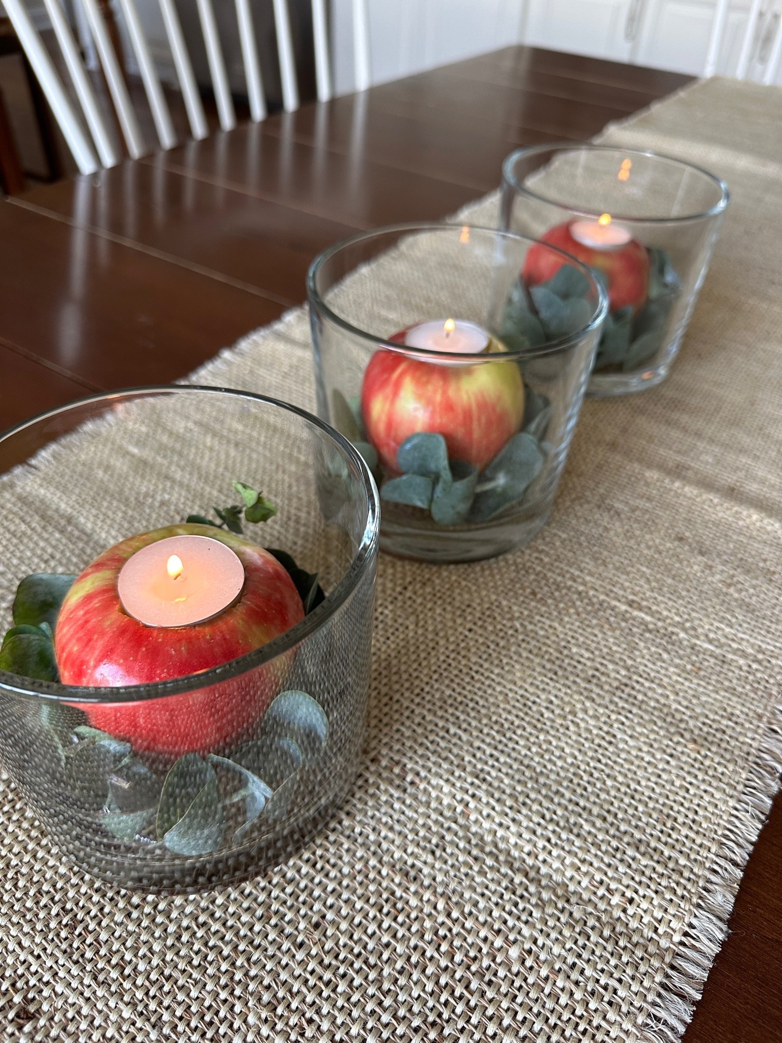 Easy Fall decor idea - carve out some apples and add a tea light candle.  Then place them in glass hurricane vases.  Instant fall centerpiece!
#ltkfall #ltkhome