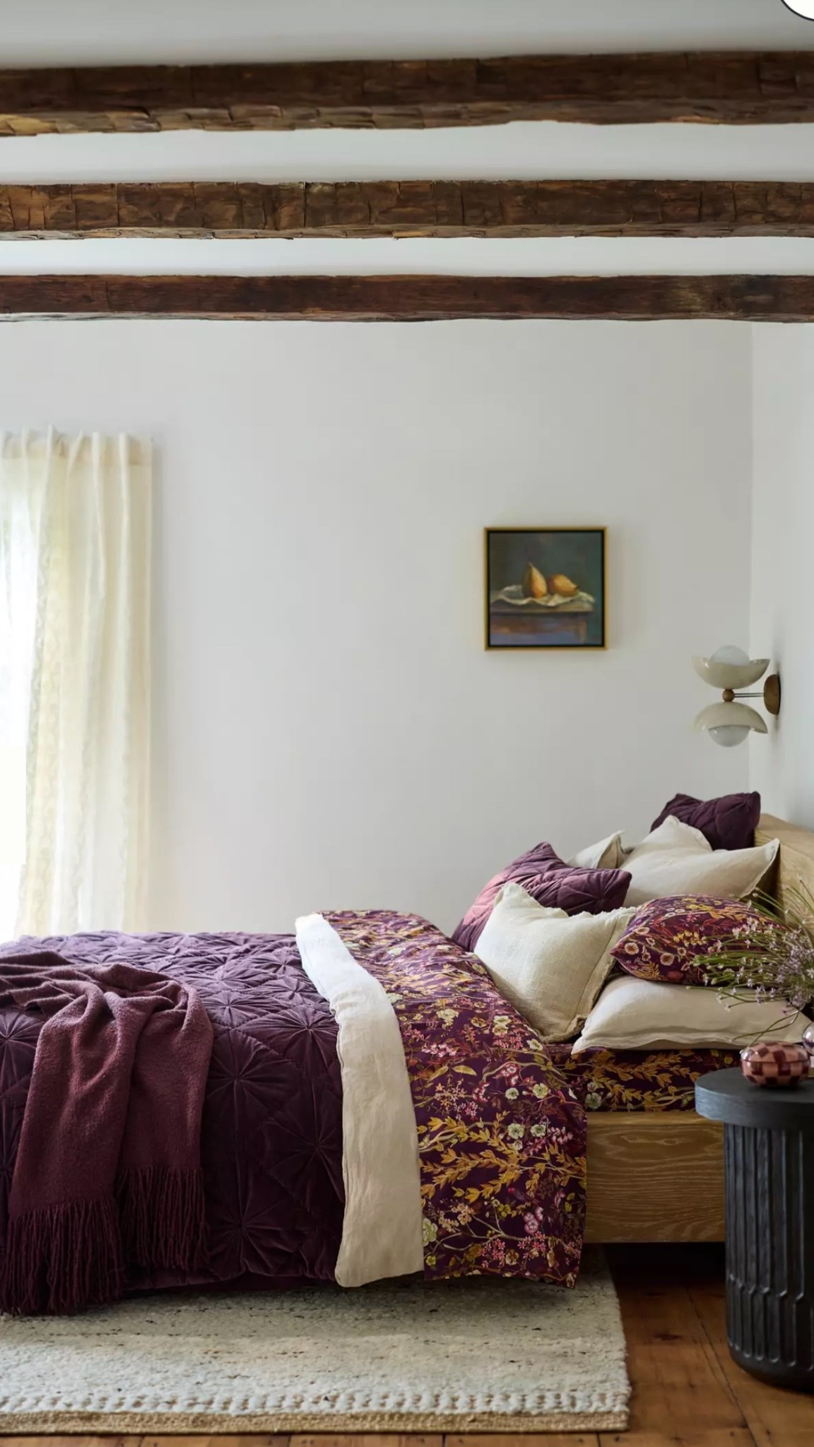 Primary bedroom has a pink couch, so the rich purple duvet complements perfectly. Add a printed sheet of stripes or florals and layer on the pillows to create a luxurious sleep in the primary suite. Don’t forget the bohemian rug, extra throw blankets in a basket, and side table trays for convenience while lounging with a good book. 