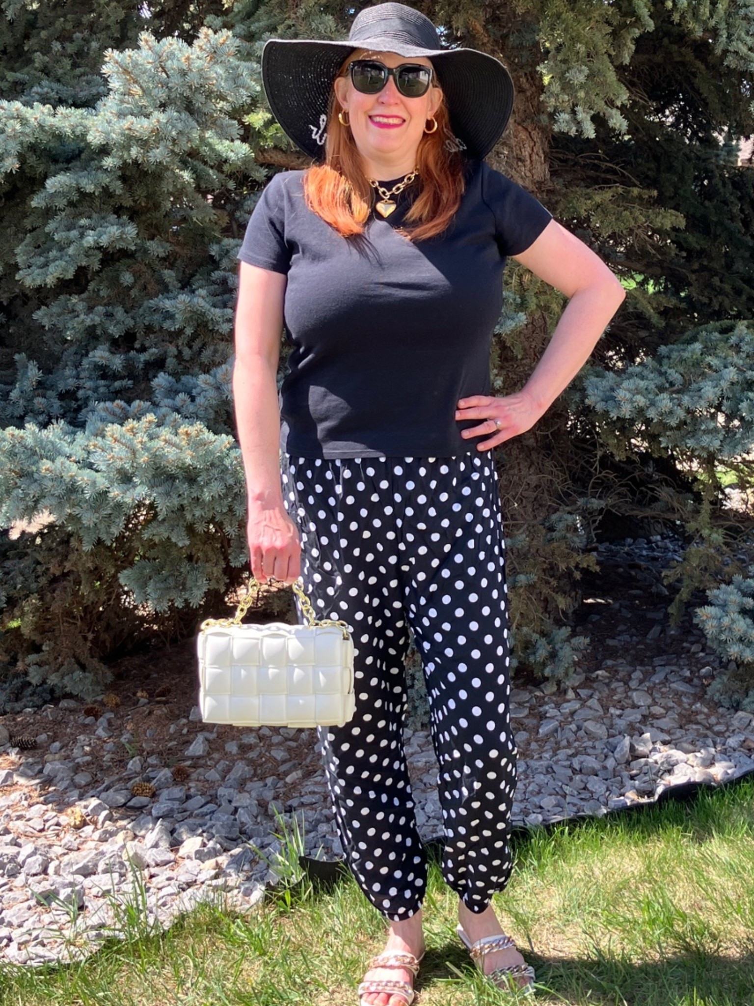 I’m not heading to Rio, but I can sure look like it! A big, floppy hat, dark sunnies, chunky heart necklace, black t, polka dot pants, and white bag and shoes and I’m ready for a vacay! Plus this look is super lightweight and comfy if you’re just chilling out on the deck for drinks. Here’s hoping the weather continues to get warmer! Canadians click on the first links to shop, and Americans click on the second links to shop. If there’s only one link then you can shop it in your own country. And remember, trendy doesn’t have to be expensive! Bye!

#LTKsummer #LTKmidsize #LTKover50style