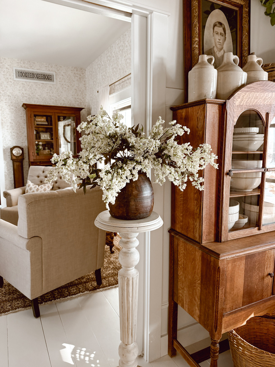 This is a cozy corner in our entryway leading into our dining room. We fill the space with neutrals and textures, and I am starting to sprinkle in my Spring faux florals.  

 #LTKSeasonal #LTKHome