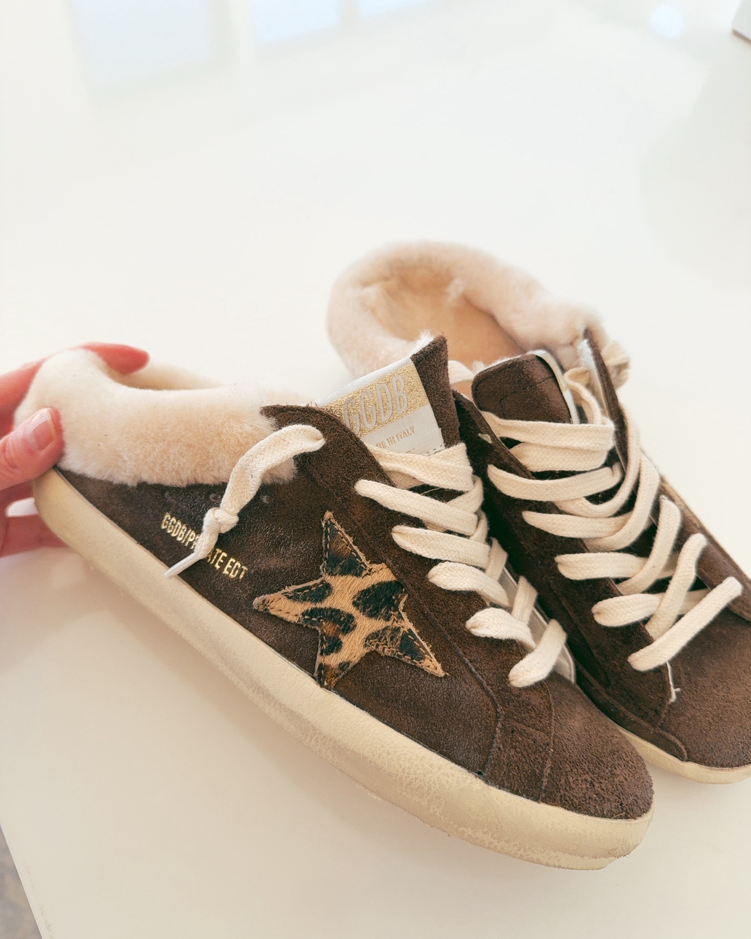 These Golden Goose sneakers are SO cute! They are slip ons that are going to feel like cozy slippers with the soft shearling lined soles. Love the brown tones and leopard print accents too! 

#LTKSeasonal #LTKOver40