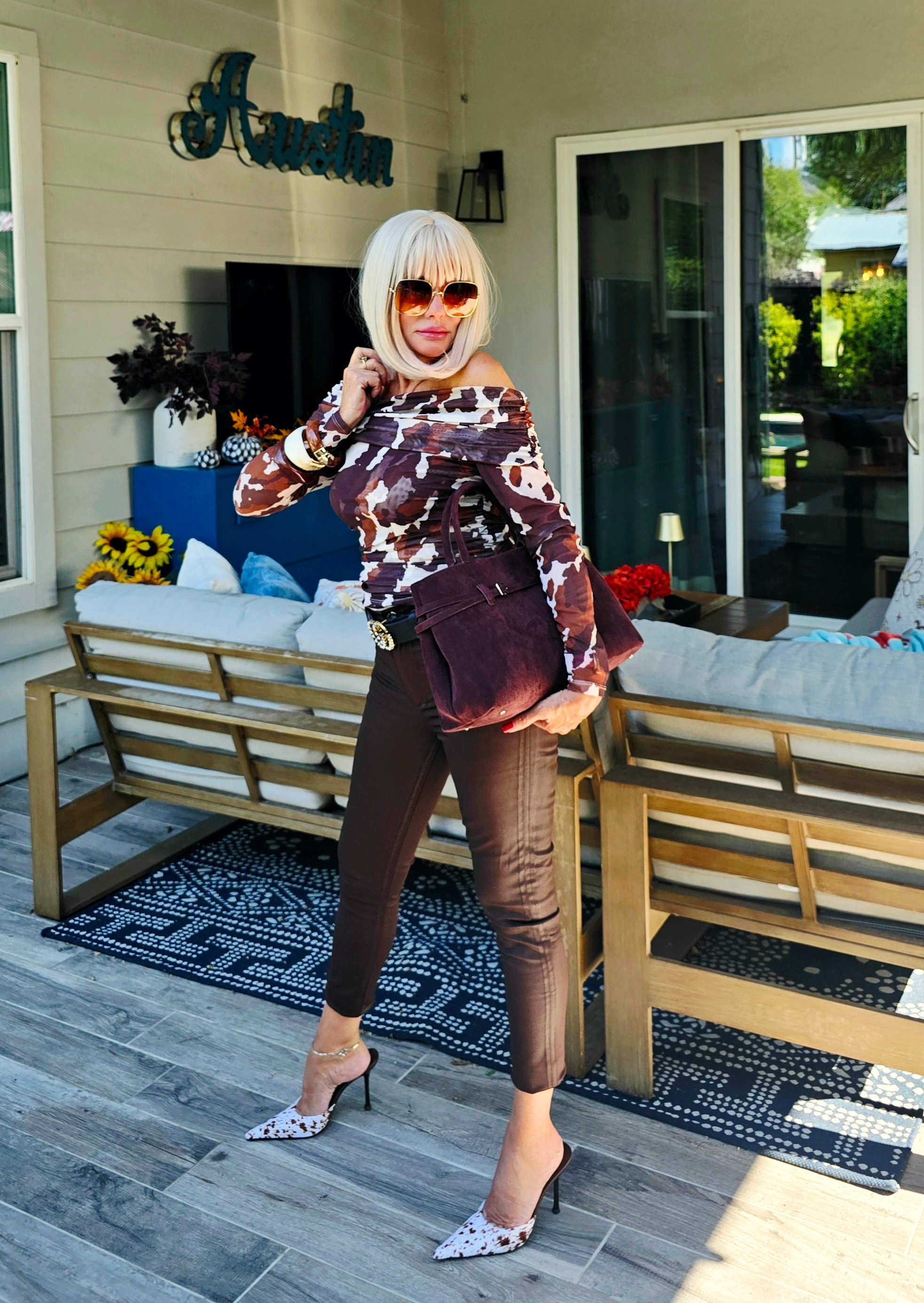 Pony print Top from Anthropologie. Suede doctor bag from Anthropologie. Jeffrey  Campbell calf hair mules. 

#LTKSeasonal #LTKActive #LTKStyleTip