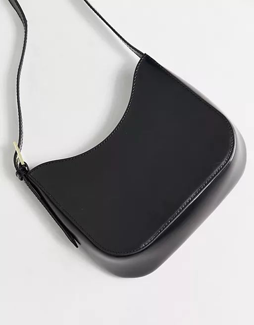 ASOS DESIGN curved leather shoulder bag with buckle strap in black | ASOS (Global)