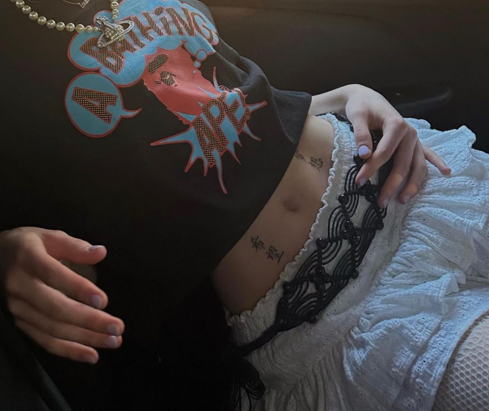 Bape t-shirt, black graphic t-shirt, layered mini skirt, white lace skirt, tassel belt, Vivienne Westwood pearl necklace 

#LTKeurope #LTKSeasonal #LTKstyletip