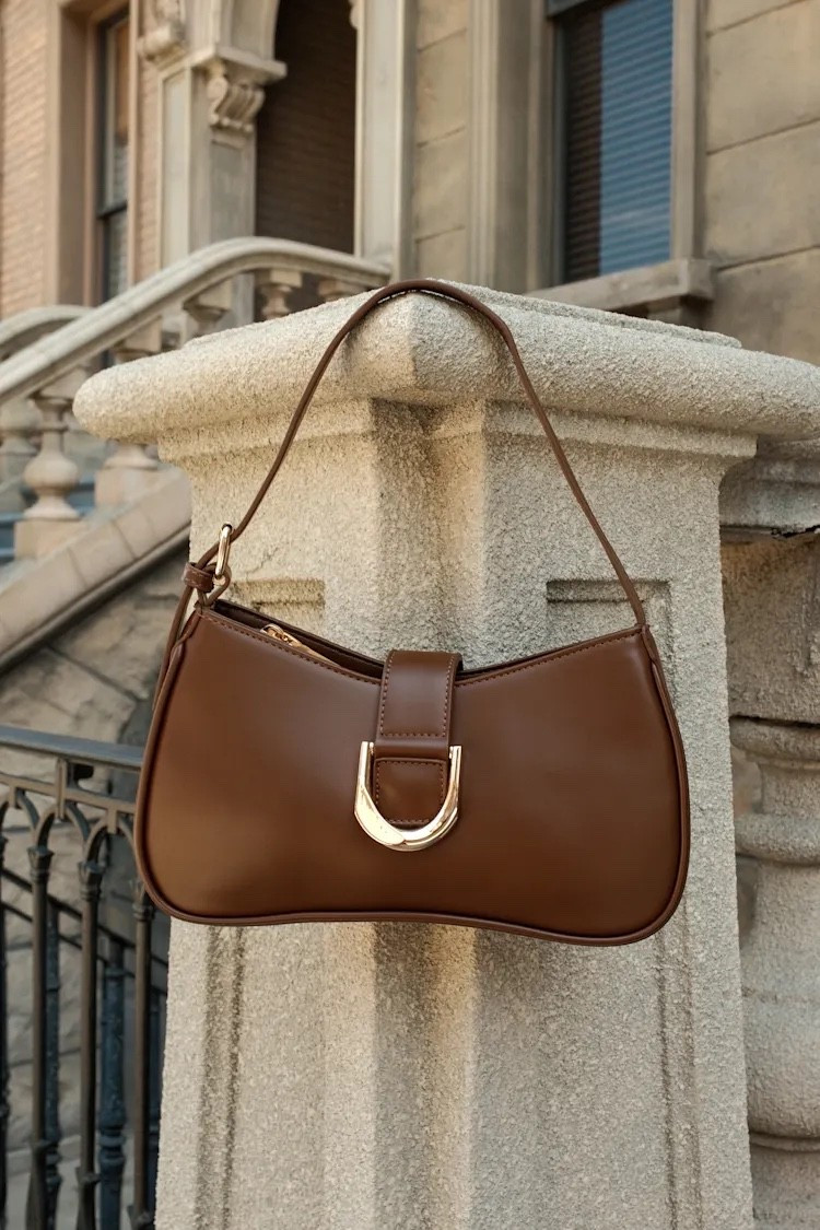 The Oh-So Chic Browh Buckle Shoulder Bag is a timeless everyday accessory with a polished, sophisticated finish. The classic brown color makes it endlessly versatile, while the buckle detail adds a subtle statement to the structured silhouette. An easy pairing with everything from tailored looks and dresses to elevated denim and casual weekend outfits. Under $50.

Ideas:

* timeless everyday accessory
* polished fall styling
* chic work outfit
* elevated casual look
* classic evening accessory

Keywords:

* brown shoulder bag
* brown handbag
* black purse
* buckle shoulder bag
* brown designer-inspired bag
* women’s handbags
* everyday handbag
* structured shoulder bag
* classic brown bag
* fall handbag
* date night outfits 
* elegant purse
* work bag
* date night bag
* faux leather handbag

#LTKgrwm #LTKootd #LTKTravel