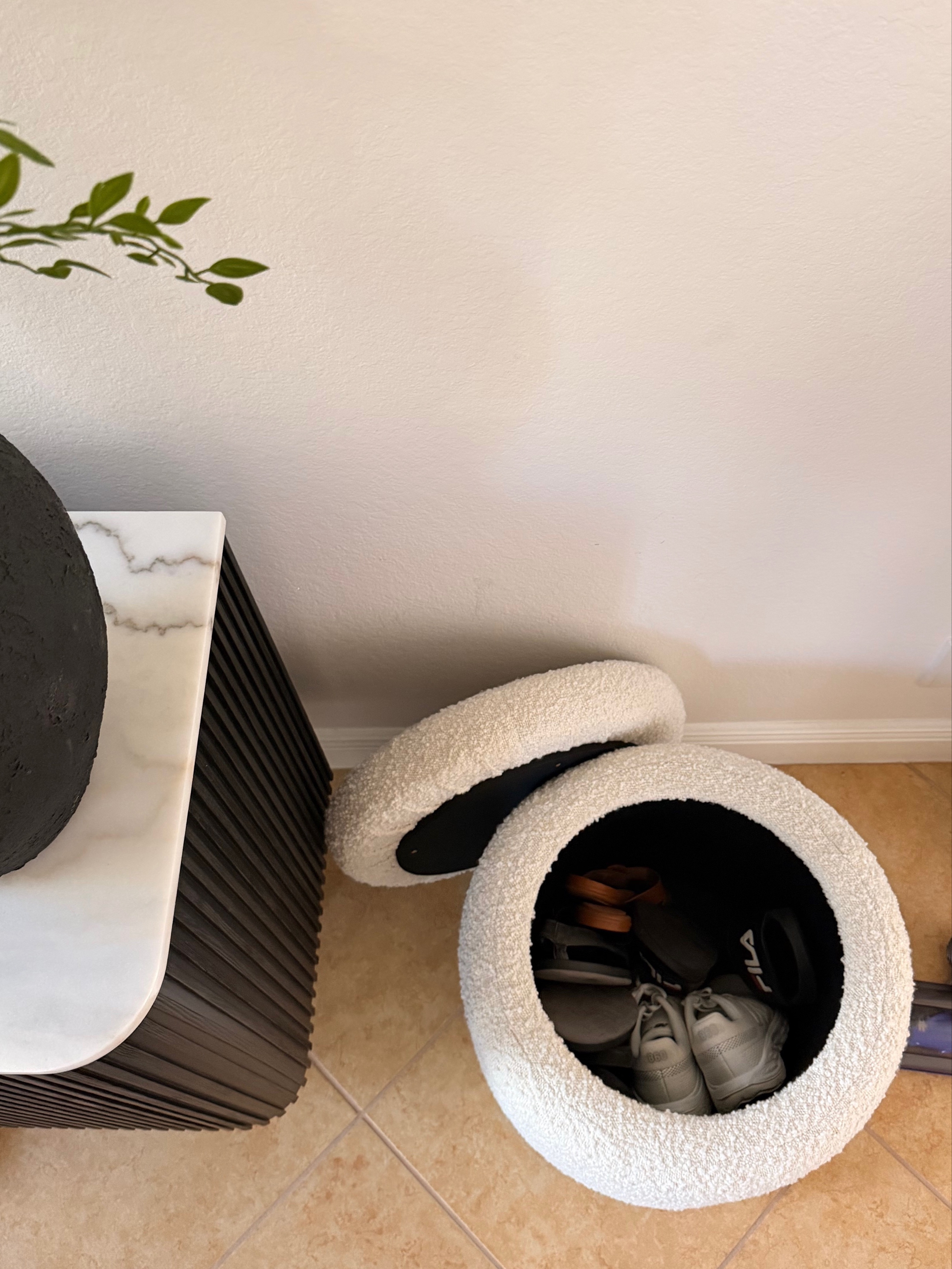 entryway hack for an organized home: keep a storage ottoman to hide shoes. loving this round boucle ottoman thats both functional storage but also super cute 

 #LTKmomlife #LTKmorningroutine #LTKHome