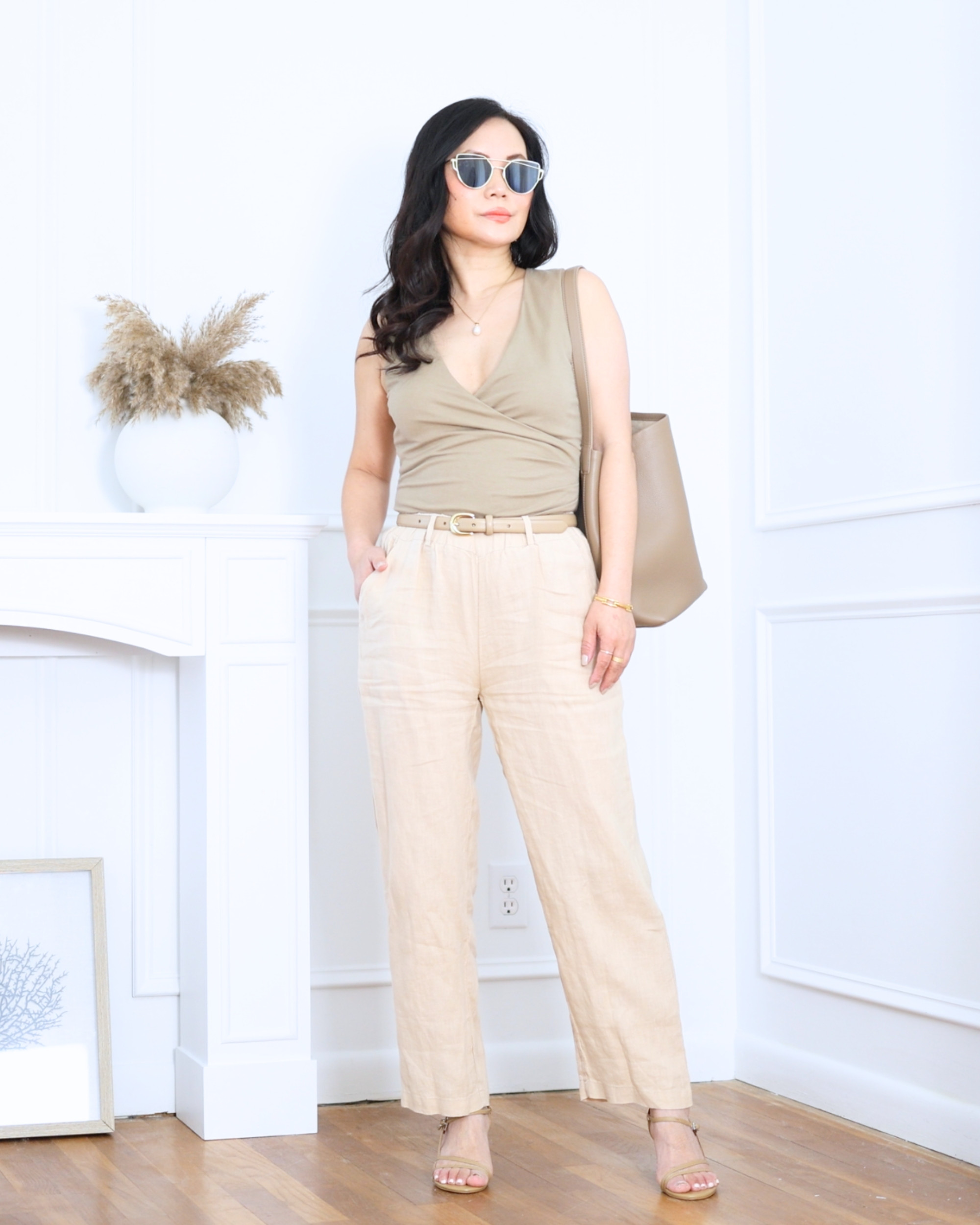Wrap top from Mango paired with linen pants, a matching bag, and strappy heels from Quince — effortlessly elegant with the perfect balance of relaxed and refined. A look that feels polished, feminine, and easy to wear from day to night. I'm 5'2, wearing size S. 

 #LTKootd #LTKOver40 #LTKPetite