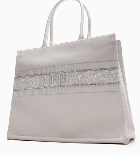 Betsey Johnson Bride Tote White. DETAILS
Looking for the perfect bachelorette tote? Look no further! This white canvas BRIDE TOTE BAG is the ultimate accessory for your special day. Make a statement as you sashay down the aisle with this beautiful and festive bag carrying all of your bridal essentials!

#LTKSeasonal #LTKstyletip #LTKwedding