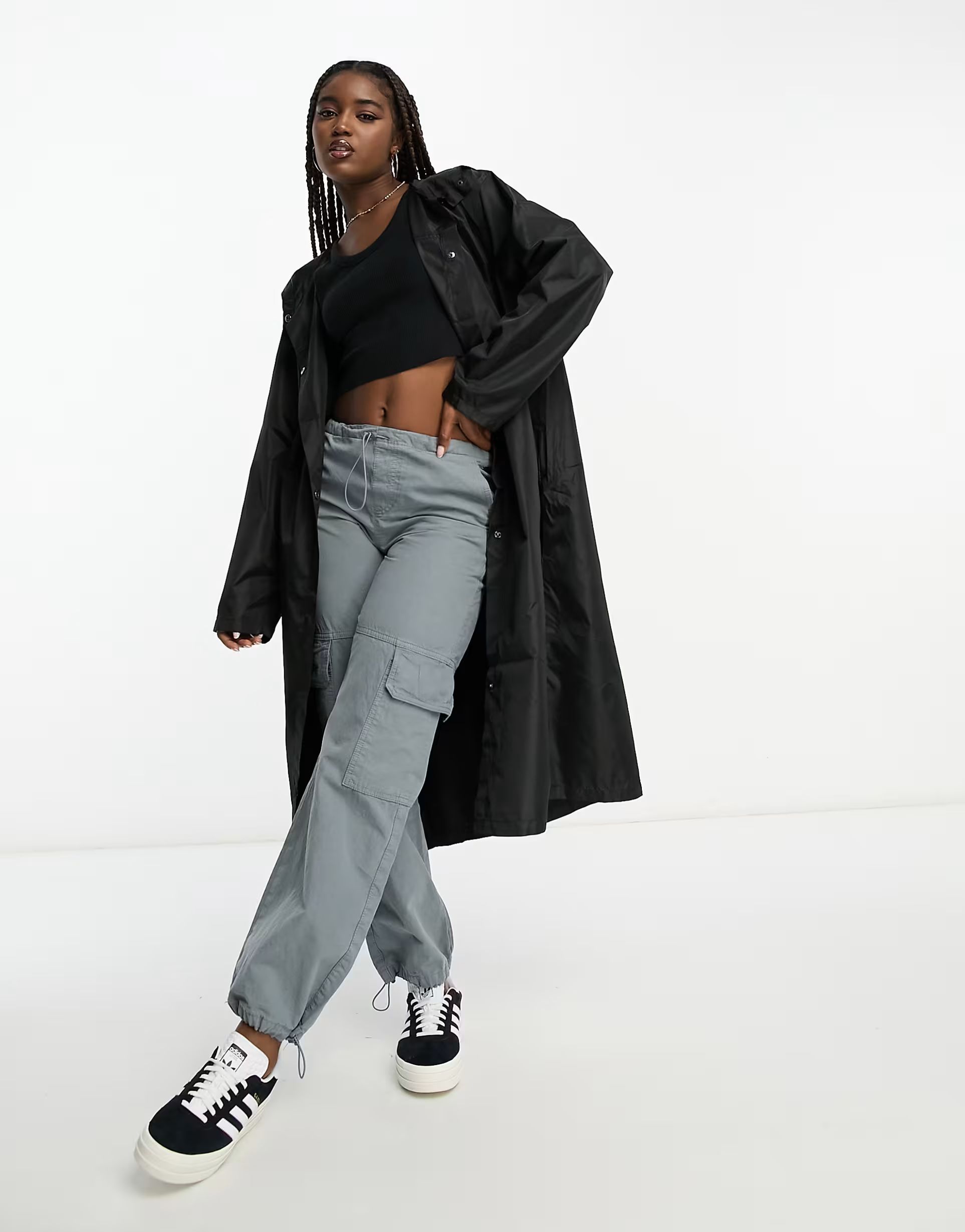 Woman in black trench coat with cargo pants and fitted top