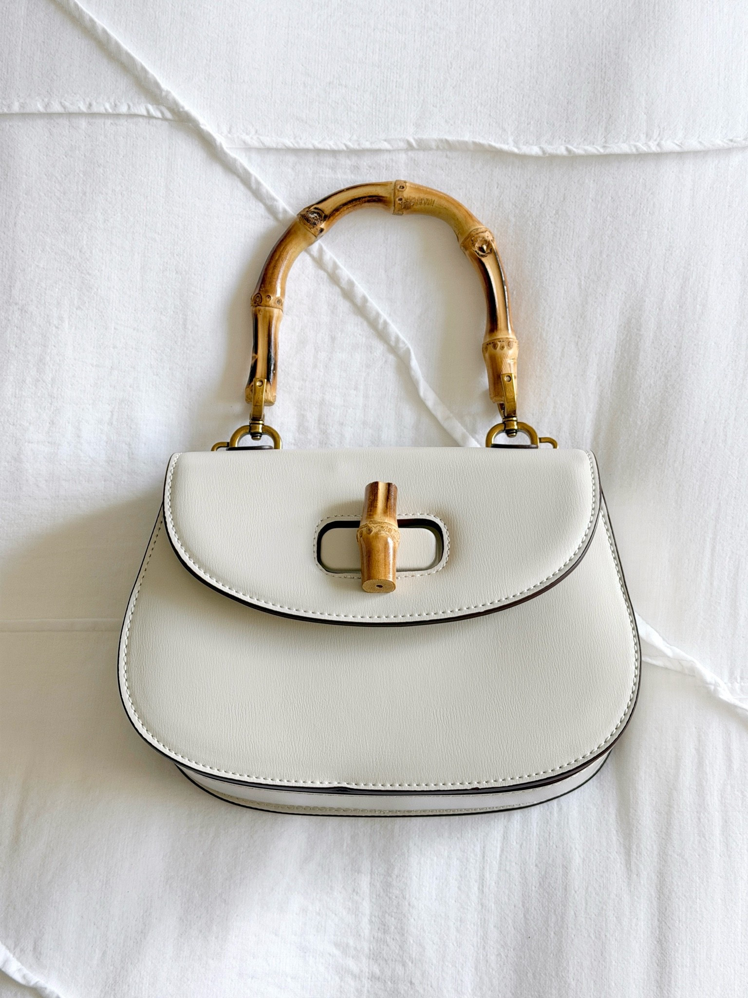 The chicest little Gucci-inspired bamboo handle bag! 🤍 Love the timeless classic look and how easy the neutral color is to style with everything. ✨ It also comes with detachable straps so you can wear it multiple ways. Such a good affordable luxury-inspired find! ☺️ #vacationstyle #summerbag #affordablefashion

#LTKSaleAlert