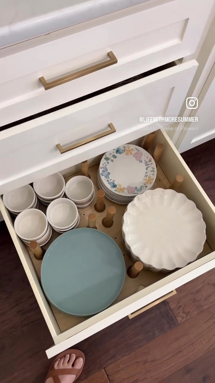 When I was thinking through the design of my kitchen cabinets, I knew I wanted my dishes in the lower cabinets instead of the uppers. I was tired of lifting a heavy stack of plates above my head to put them away or straining to take them down.

I asked the custom cabinet maker we were working with to get a peg board insert for the two lower drawers with many wooden pegs, so I could adjust my dish configuration as needed. 

Incase you’re wondering, the wooden pegs keep the plates and bowls from hitting one another as the drawer opens and closes. 

5 years later, I have no regrets on this kitchen design choice. I’d do it again & recommend it to anyone starting kitchen renovations or building a new home.
.
.
.
.
kitchen cabinet planning | kitchen design | kitchen planning | kitchen organizing | kitchen organization | drawer design | dish storage | plate storage | custom cabinets | plate drawer