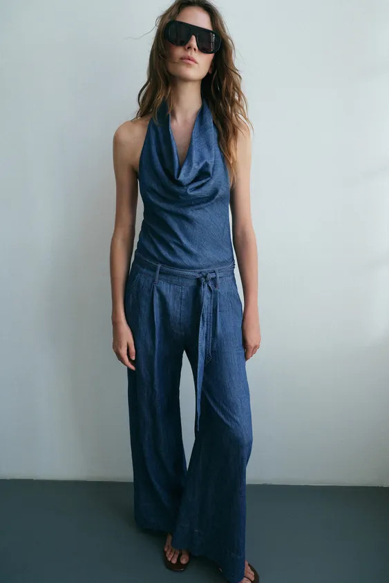 Halter neck jumpsuit with an open back. Features a matching fabric belt and contrasting topstitch... | Zara US