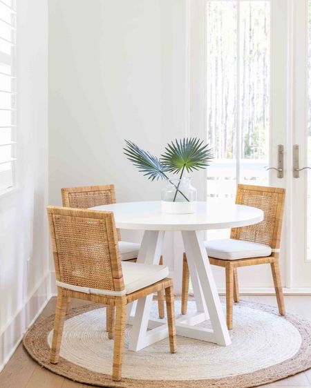 Our Florida carriage house dining area! I love this round white dining table (a budget find!) paired with these rattan dining chairs. Also linking our round jute rug, colorblock vase and faux tan palm stems. You can take the full carriage house tour here: https://lifeonvirginiastreet.com/our-florida-carriage-house-tour/.
.
#ltkhome #ltksalealert #ltkstyletip #ltkseasonal #ltkfindsunder50 #ltkfindsunder100 #ltktravel small dining area ideas, round rug

#LTKSeasonal #LTKSaleAlert #LTKHome