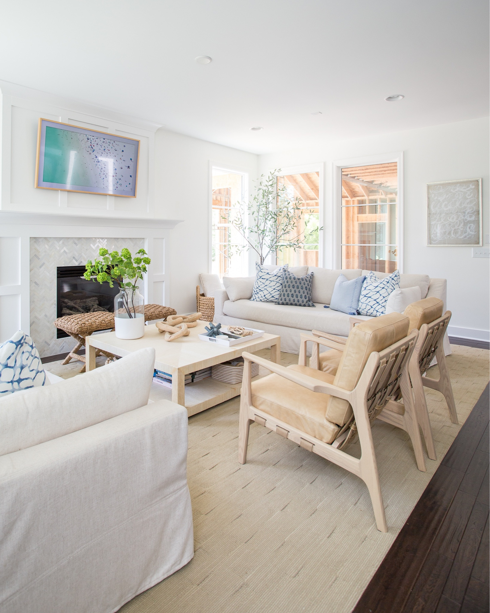 Items in our previously coastal inspired living room include decorative pillows, a slip covered sofa, tan leather chairs, a raffia coffee table, x-base stools, paint dipped vase with faux greenery, a wooden chain, The Frame TV and a faux fiddle fig leaf tree.  Additional items not shown include a black sofa console, a wooden bowl, glass table lamps and an indigo wall canvas. 

simple decor, family room, living room décor, Amazon finds, etsy pillows, amazon home decor, pottery barn living room, family room decor, coffee table decor, pb inspired room, pottery barn décor, pottery barn furniture, pottery barn sofa, pottery barn throw, coastal decorating, coastal design, coastal inspiration, pottery barn dining room, pottery barn art, canvas wall art, art for home, neutral decor, simple style, wall art, simple decorating #ltkfamily #ltkfind  

#LTKSeasonal #LTKstyletip #LTKunder50 #LTKunder100 #LTKhome #LTKsalealert #LTKFind #LTKSeasonal #LTKhome