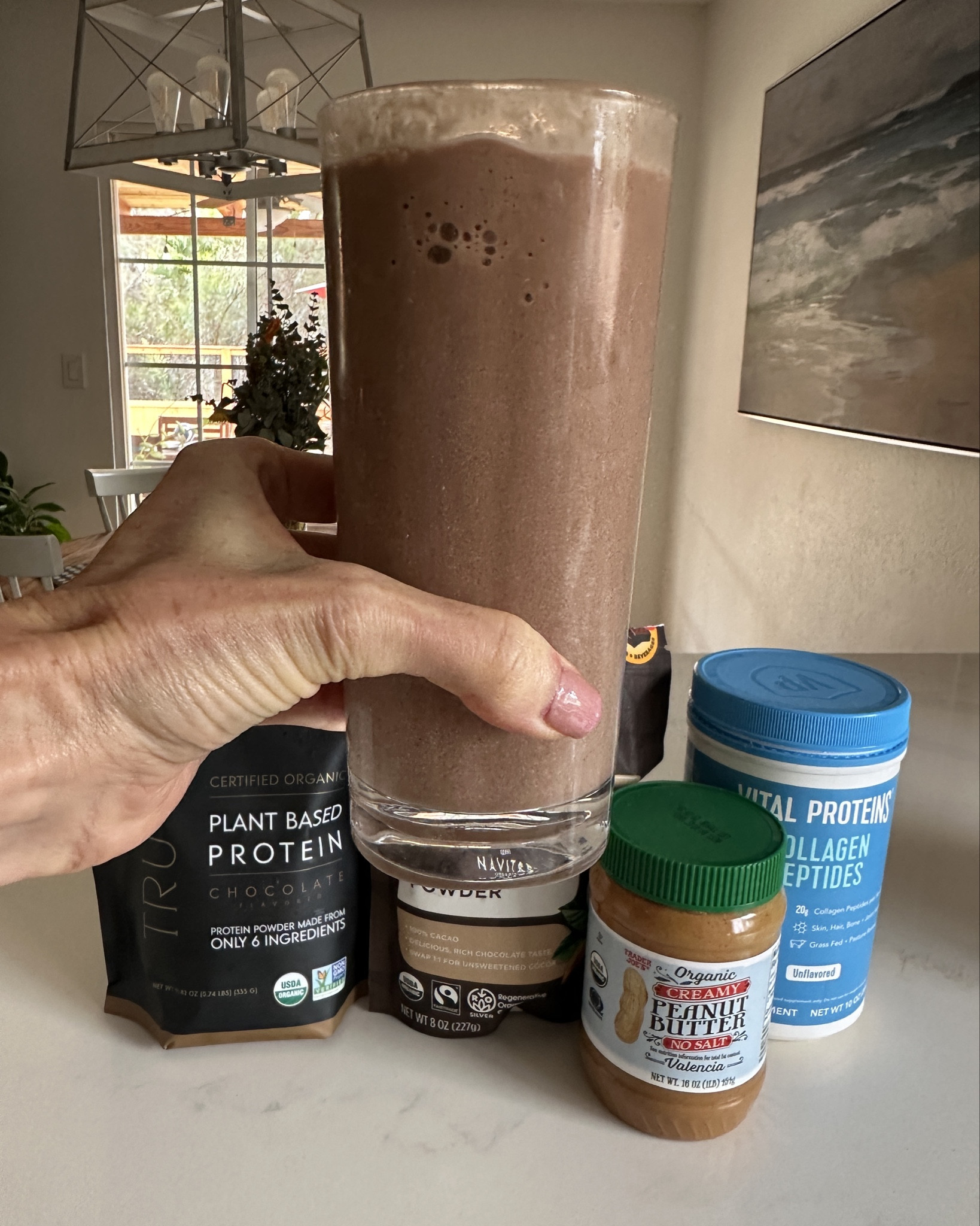 Meg’s Chocolate PB Protein Shake 🍫✨
My go-to healthy milkshake moment — thick, creamy, and packed with protein + collagen.
Made with Truvani chocolate protein, cacao, peanut butter, frozen banana, and almond milk.
Wellness made simple (and delicious).

🥄 Meg’s Chocolate PB Shake:
• 1 frozen banana
• 1 scoop Truvani Chocolate Protein
• 1 tbsp peanut butter
• 1 tbsp collagen
• 1–2 tsp raw cacao
• ¾–1 cup almond milk
• Handful of ice
Blend until creamy and thank me later. 🤎

#LTKHome #LTKActive #LTKOver40
