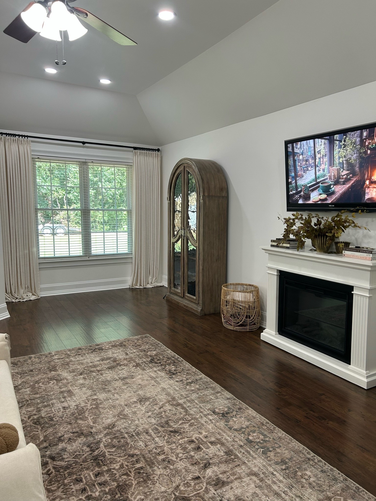 Primary Bedroom Curtain, Curio, Fireplace and Rug

#LTKHome #LTKSeasonal