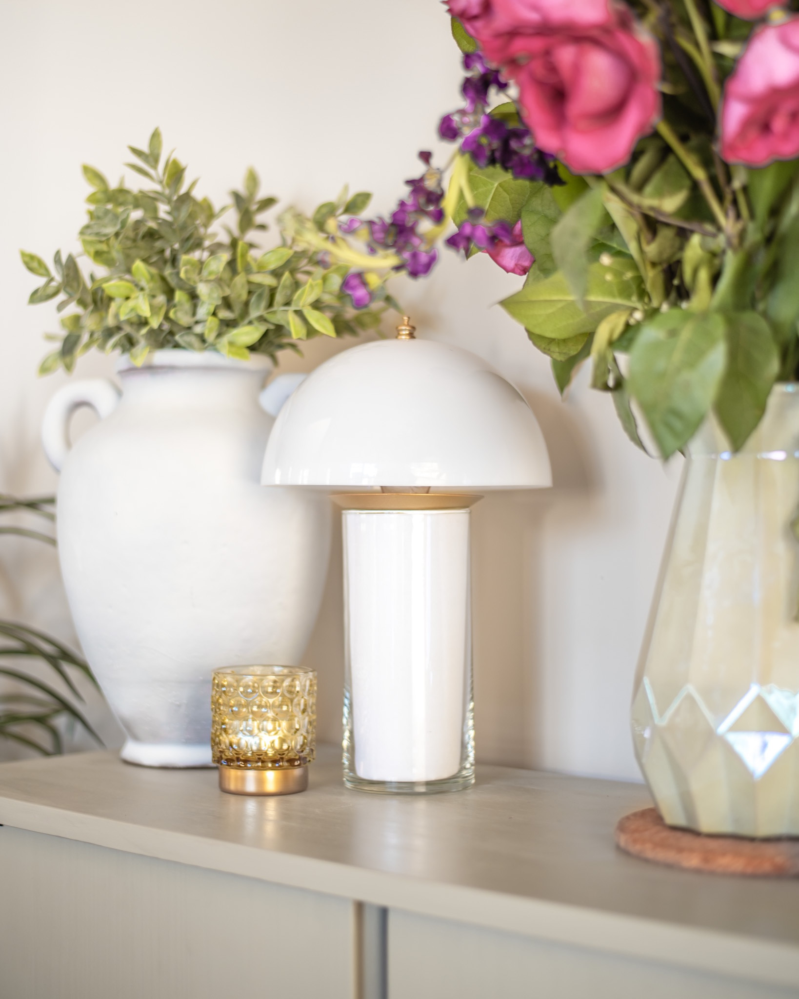 DIY this modern vintage mushroom lamp with no paint and no mess.  

1. Clip-on lamp shade attached to an LED lantern
2. Place a puck light in the bottom of a clear vase.
3.  Line the vase with a white sheet of paper by rolling it into a cylinder and trimming off the excess paper.
4.  Place the shade on to of the vase and voila!
5.  Add optional fairy lights for a brighter lamp!

#diyhomedecor #homedecor #diyprojects





#LTKhome #LTKunder100 #LTKunder50