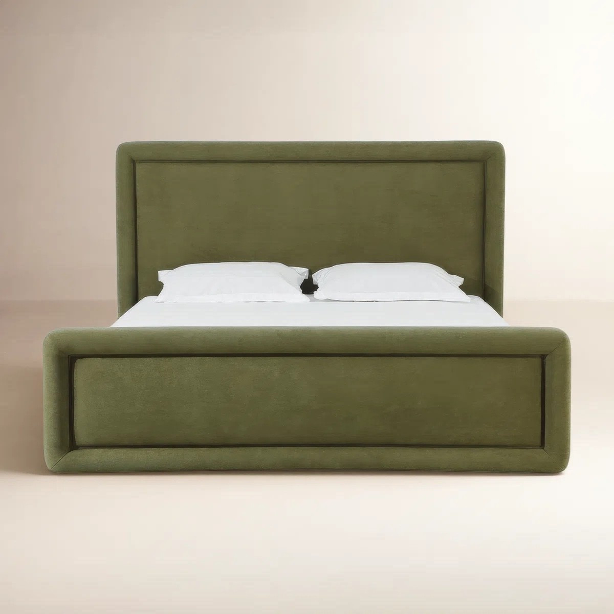 This olive green upholstered low-profile bed from Joss & Main is such a beautiful bedroom statement. I love the oversized padded headboard, matching upholstered footboard, and softly rounded edges for a clean, cozy look. Styled with simple white bedding, the rich green upholstery really gets to be the focus. It’s currently marked down at Joss & Main. #JossAndMain #UpholsteredBed #GreenBedroom #BedroomFurniture