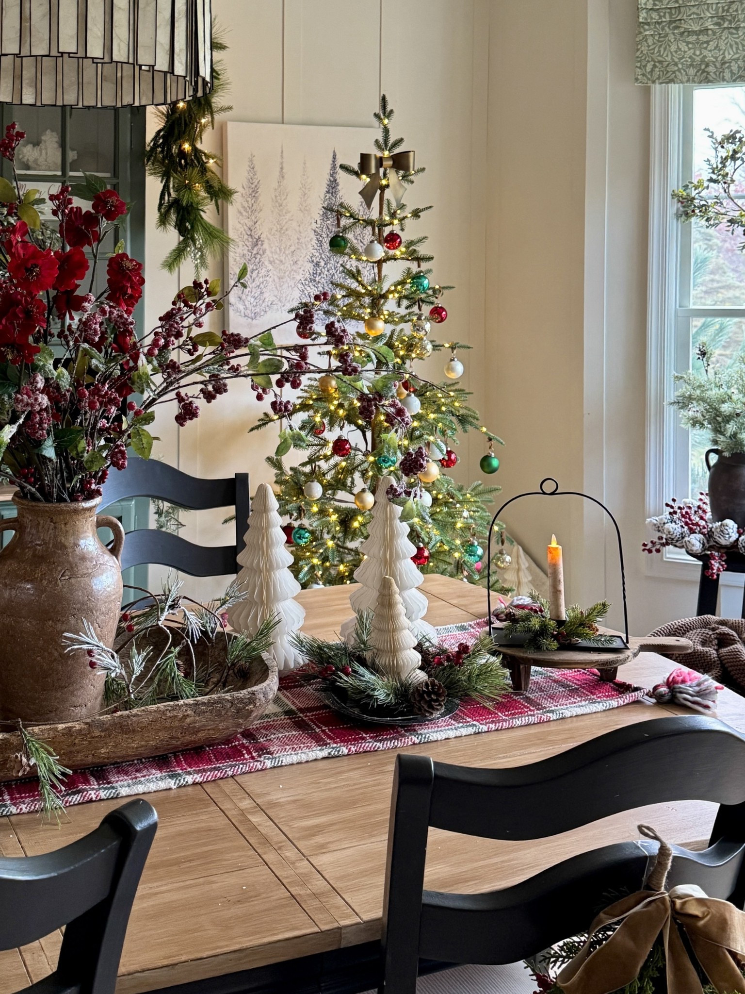 Simple Christmas tablescape using my very favorite white honeycomb Christmas trees. Table runner. Checkered patterned wood risers. Pretty black candle holder that you can actually hang if you’d like. I paired it with a flickering battery operated candle and candle ring. White scalloped plates. Similar  nativity to mine. White Christmas tree wall print. The sparse Christmas tree is my favorite 7’ Balsam Hill Alpine Balsam Fir Tree with clear LED  Fairy Lights. 

#LTKSeasonal #LTKHoliday #LTKHome