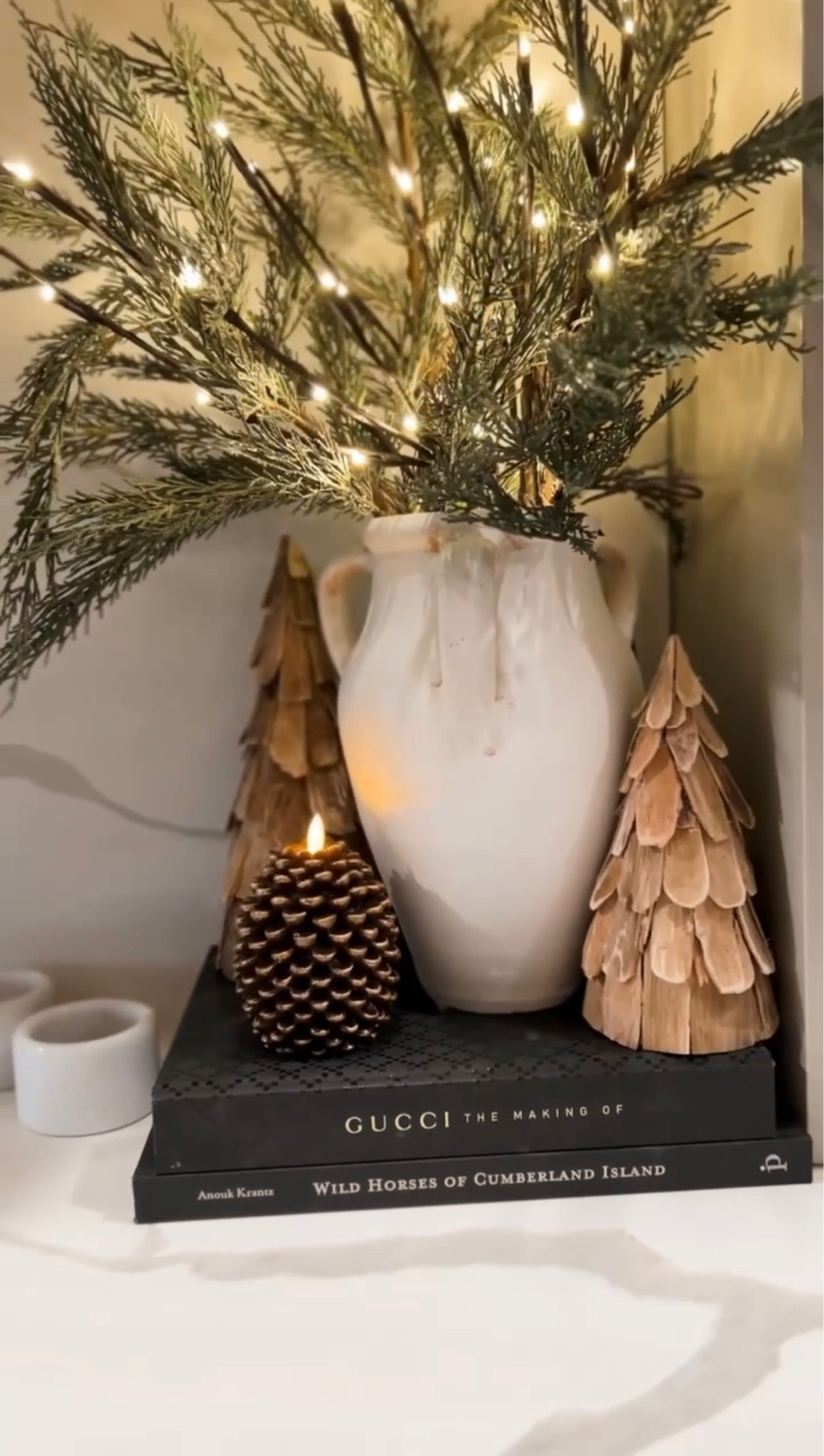 Pine cone reel - linking all I can in this scene. / Christmas home decor / amazon home decor / pottery barn / white ceramic vase / cedar branches / pre lit branches / easy Christmas decor / holiday home / modern organic home / Christmas tree decor / target 

#LTKHoliday #LTKSeasonal #LTKhome
