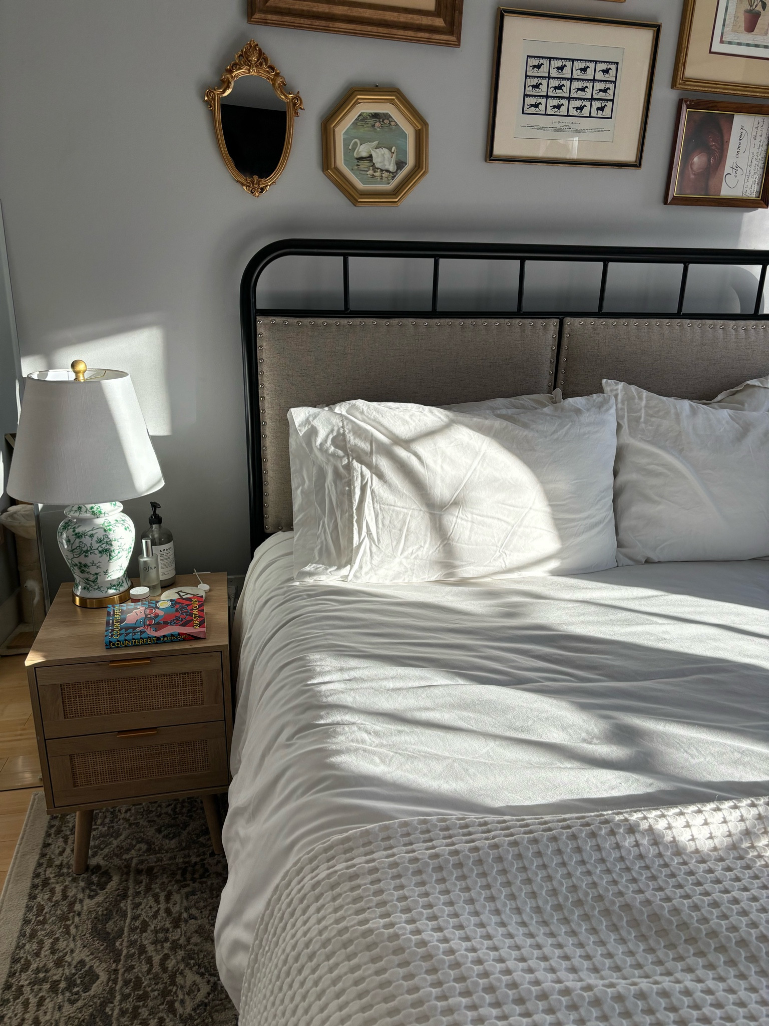 Queen bed with white bedding and rattan nightstand 

#LTKHome