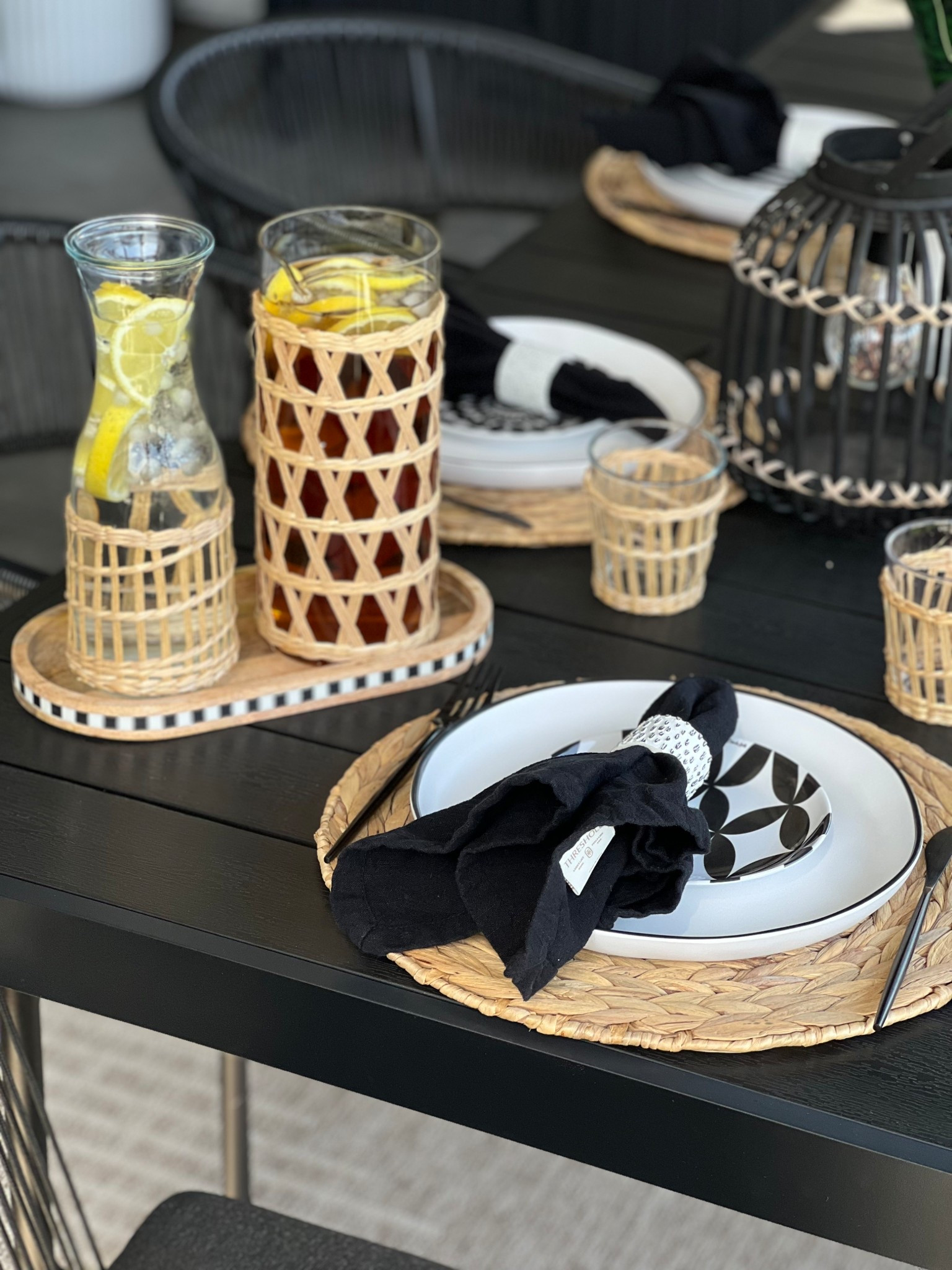 A modern alfresco dining setup layered on a black outdoor table with woven placemats, black and white dinnerware, linen napkins, lantern lighting, and a simple sip station for a look that feels elevated, relaxed, and perfect for outdoor brunch or gathering; alfresco dining, outdoor dining table, outdoor brunch ideas, backyard entertaining, outdoor tablescape, black outdoor table, woven placemats, black and white dinnerware, linen napkins, lantern decor, outdoor lighting, sip station, drink station, infused water, outdoor hosting ideas, patio table setting, modern outdoor decor, entertaining at home, hosting essentials, modern hostess

#LTKHome #LTKSeasonal