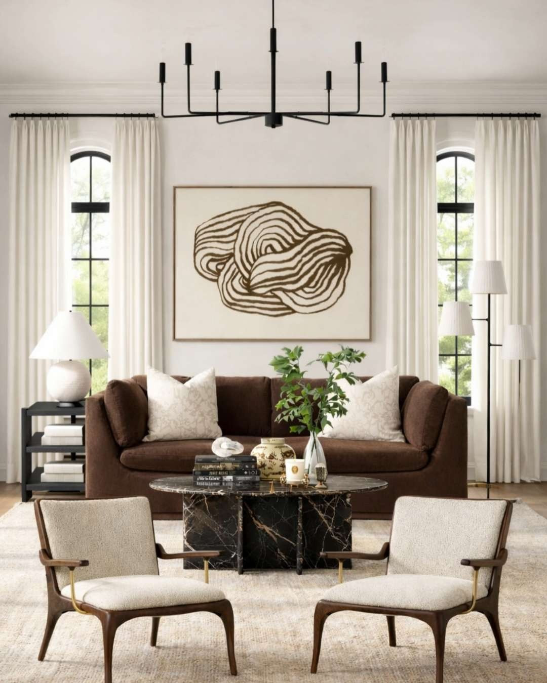 From moodboard → to fully realized space. ✨

This is exactly why I love starting with a moodboard. It lets you see how the materials, tones, and silhouettes will work together before anything is actually in the room.

Here the vision was warm, sculptural, and layered — rich brown upholstery, soft neutral textiles, black metal accents, and dramatic marble grounding the space. The abstract artwork anchors the wall while the mix of textures (bouclé, linen, marble, wood) keeps everything feeling elevated and balanced.

Seeing the concept translate into a finished room is always the best part.

If you love warm modern interiors, designer living rooms, layered neutrals, and sculptural furniture, this is a perfect example of how a moodboard becomes a room. ✨ 

 #LTKHome