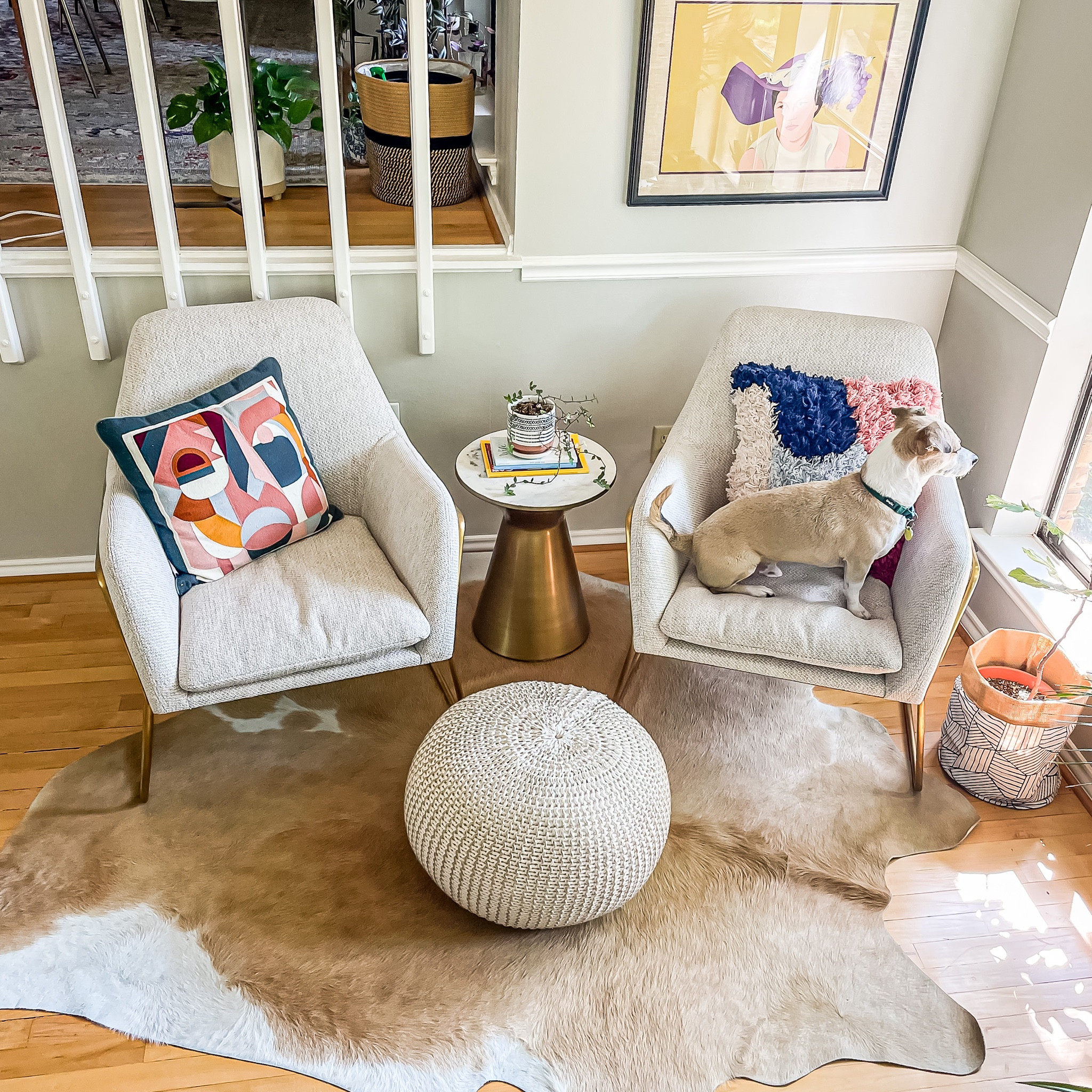 Modern reading nook or conversation corner. We absolutely love these comfy, modern chairs. A cowhide rug adds a bit of softness and a touch of natural to the brass elements. Add a gold pouf and side table and you have a great vignette  

#LTKstyletip #LTKsalealert #LTKhome