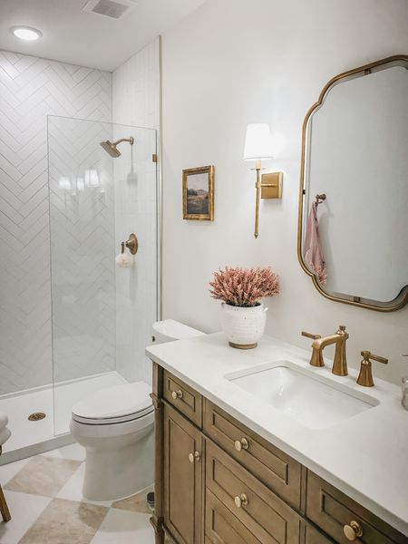 Guest bathroom views! To break up a stark white bathroom I incorporated warm woods and gold details to warm up the space 

Home design, guest bathroom, bathroom refresh, style inspo, light and bright, pops of pink for the fall, creamy whites, warm wood tones, neutral home, gold detail, home refresh, bathroom info, guest bath finds, Wayfair, Michaels, Amazon, Target, Home Depot, aesthetic home, faux florals, vanity finds, gold fixture, shower glass panel, pink robe, home decor, bath detail, shop the look!

#LTKstyletip #LTKSeasonal #LTKhome