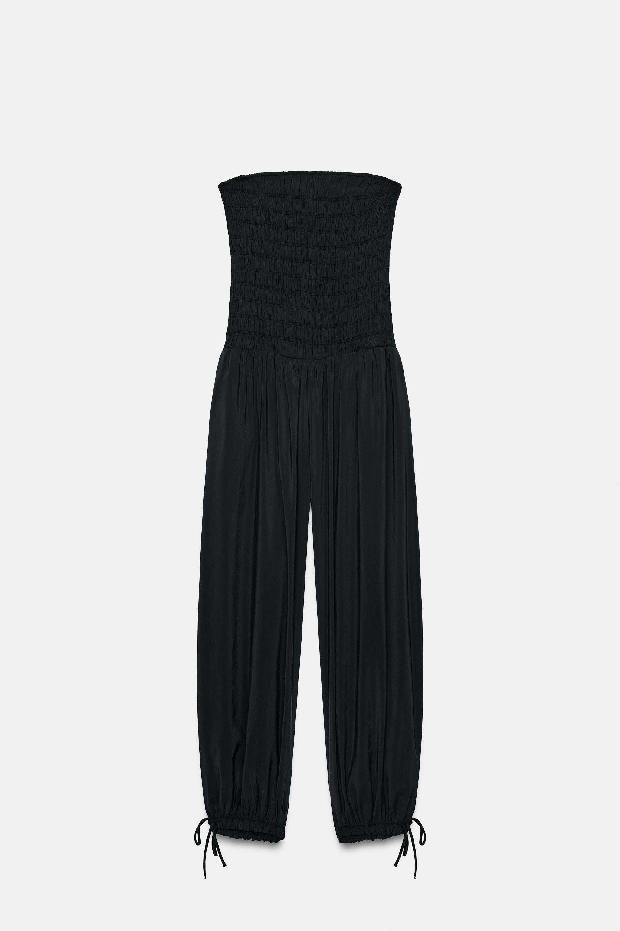 Jumpsuit made of flowy fabric. Straight neckline and off-the-shoulder design. Elastic gathered de... | Zara US
