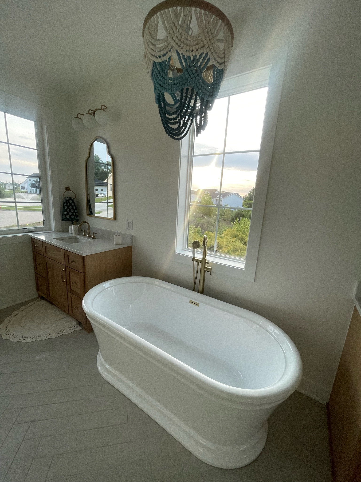 Primary Bathroom Fixtures // Turquoise Teal Beaded Chandelier above bath tub // Delta Sink and Bath Fixtures // Bathroom Light Fixtures // Vintage Tub and Bath Madera 67 Inch // Husk Homes // Custom Built Homes of Iowa 22 

#LTKHome