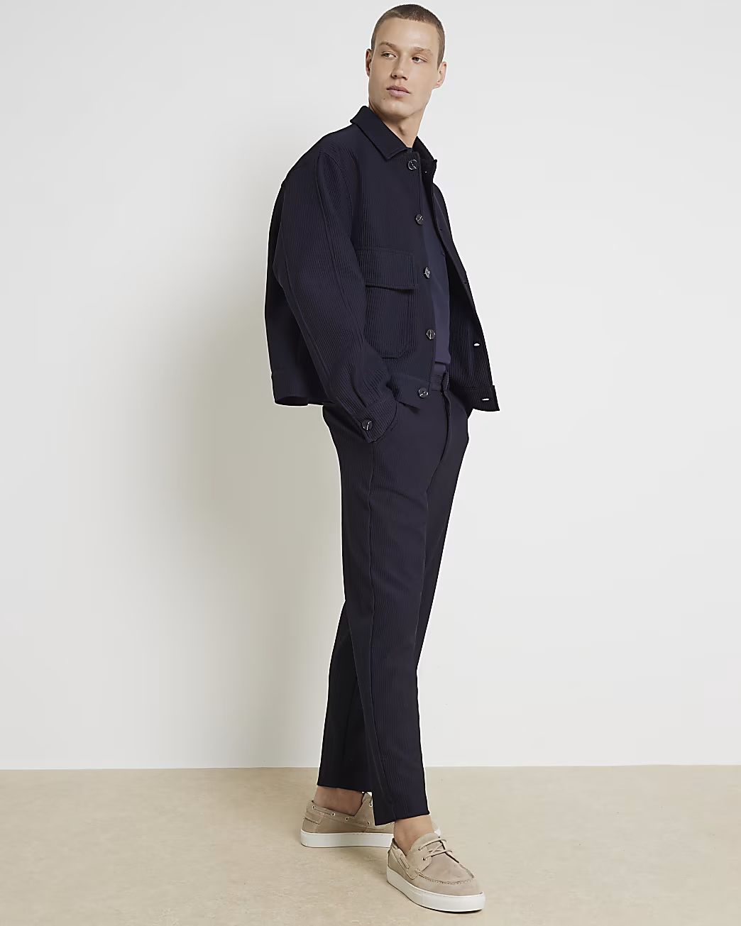 Navy tapered fit plisse smart trousers | River Island (UK & IE)