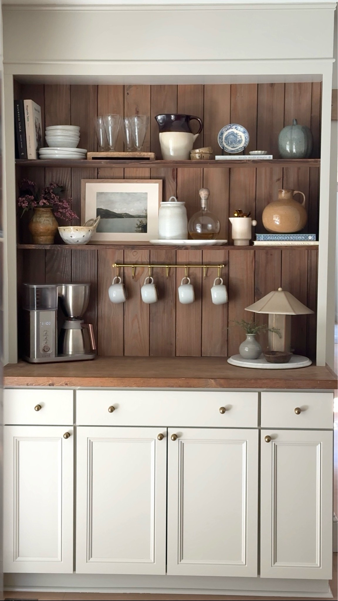 warm wood tones • coffee bar styling • kitchen hutch • cozy kitchen decor • neutral home decor • vintage inspired decor • collected home • open shelf styling • ceramic accents • brass details • kitchen organization • coffee station • cottage style • traditional decor • modern vintage • affordable home finds • Amazon home finds • kitchen inspiration• ceramic table lamp • scalloped lamp shade • faux greenery • ceramic vase • marble tray • wood decorative bowl • stoneware pitcher • ceramic crock • glass decanter • vintage style vase • framed landscape art • blue and white plate • coffee mugs • brass mug rack • coffee maker • ceramic bowls • stoneware dishes • decorative books • kitchen shelf decor • coffee bar accessories • Amazon kitchen finds • affordable home decor • target • McGee & co • fall home decor

#LTKHome #LTKSaleAlert
