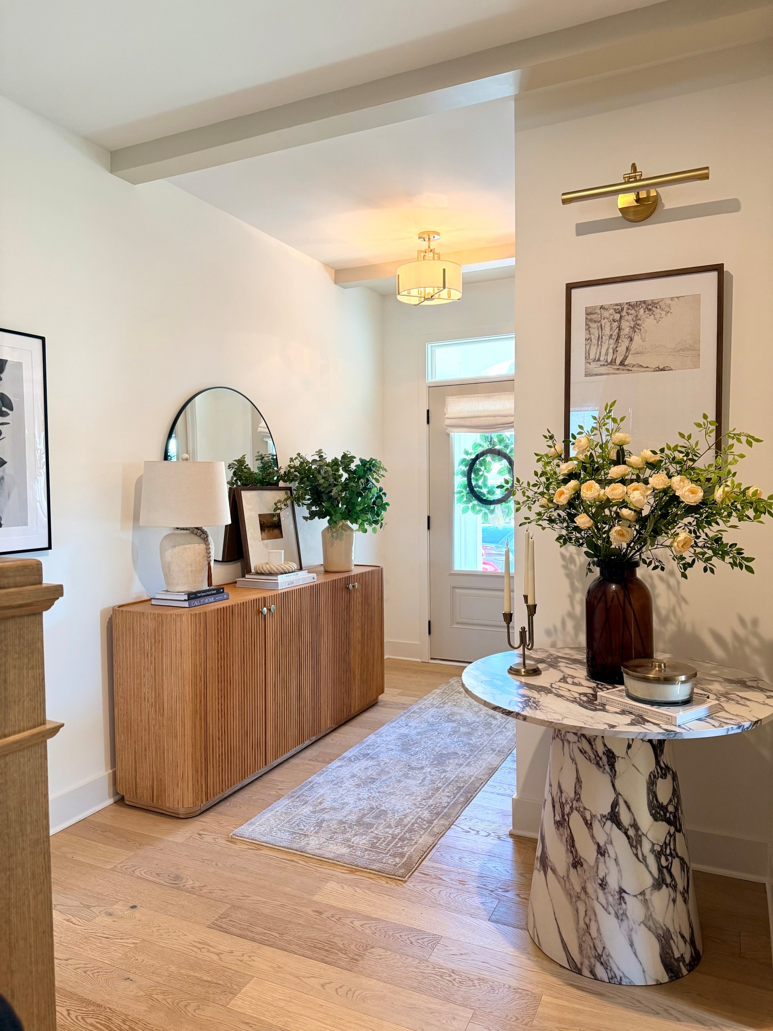 Our foyer is finally coming together and it feels like such a warm welcome home 🤍

I wanted this space to feel cozy, elevated, and curated the moment you walk in. The fluted wood sideboard adds so much texture and warmth, layered with greenery, neutral lamps, and classic artwork. And this marble pedestal table moment… she deserves her own spotlight ✨

Soft brass lighting, a vintage-inspired runner, and creamy florals tie everything together for that timeless, modern heritage feel I’m always leaning into.

#LTKHome #LTKvlog #LTKOver40