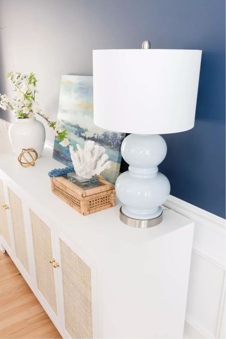 Coastal decor idea for white console table styling! Featuring my blue lamp, cane and rattan box, recycled glass beads, and coral decorative items 
6/2

#LTKHome #LTKStyleTip