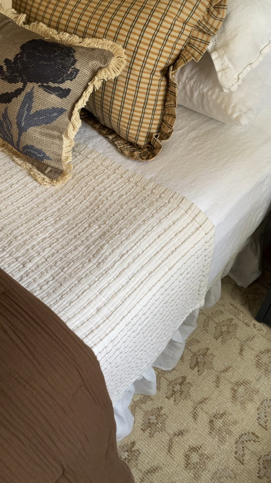 The chocolate quilt, linen sheets, and hand-knotted wool rug I’m using in our bedroom makeover. All from @onequince! #quincepartner