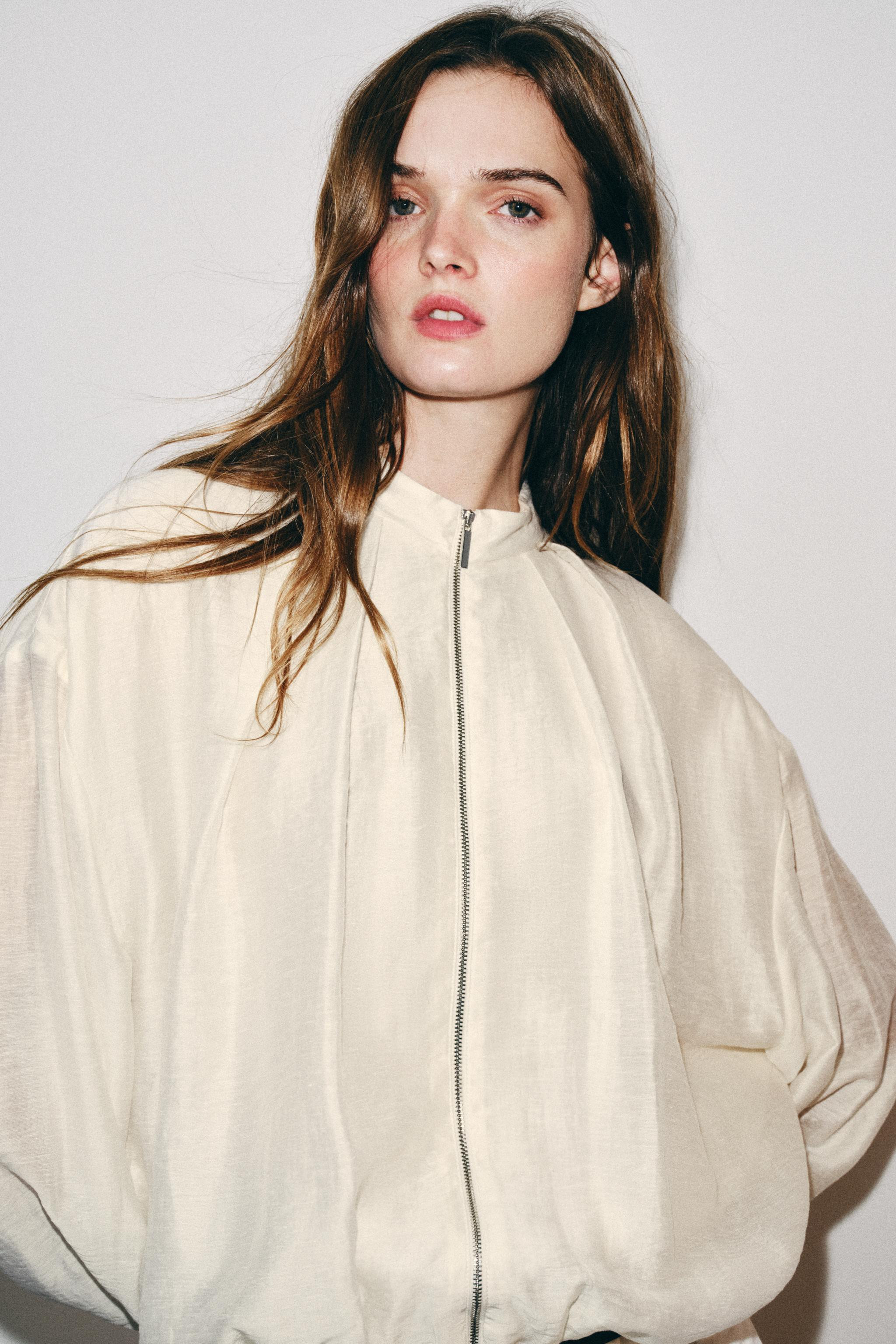 High neck, long sleeve jacket. Featuring side pockets concealed in the seams, elastic trims and p... | Zara UK