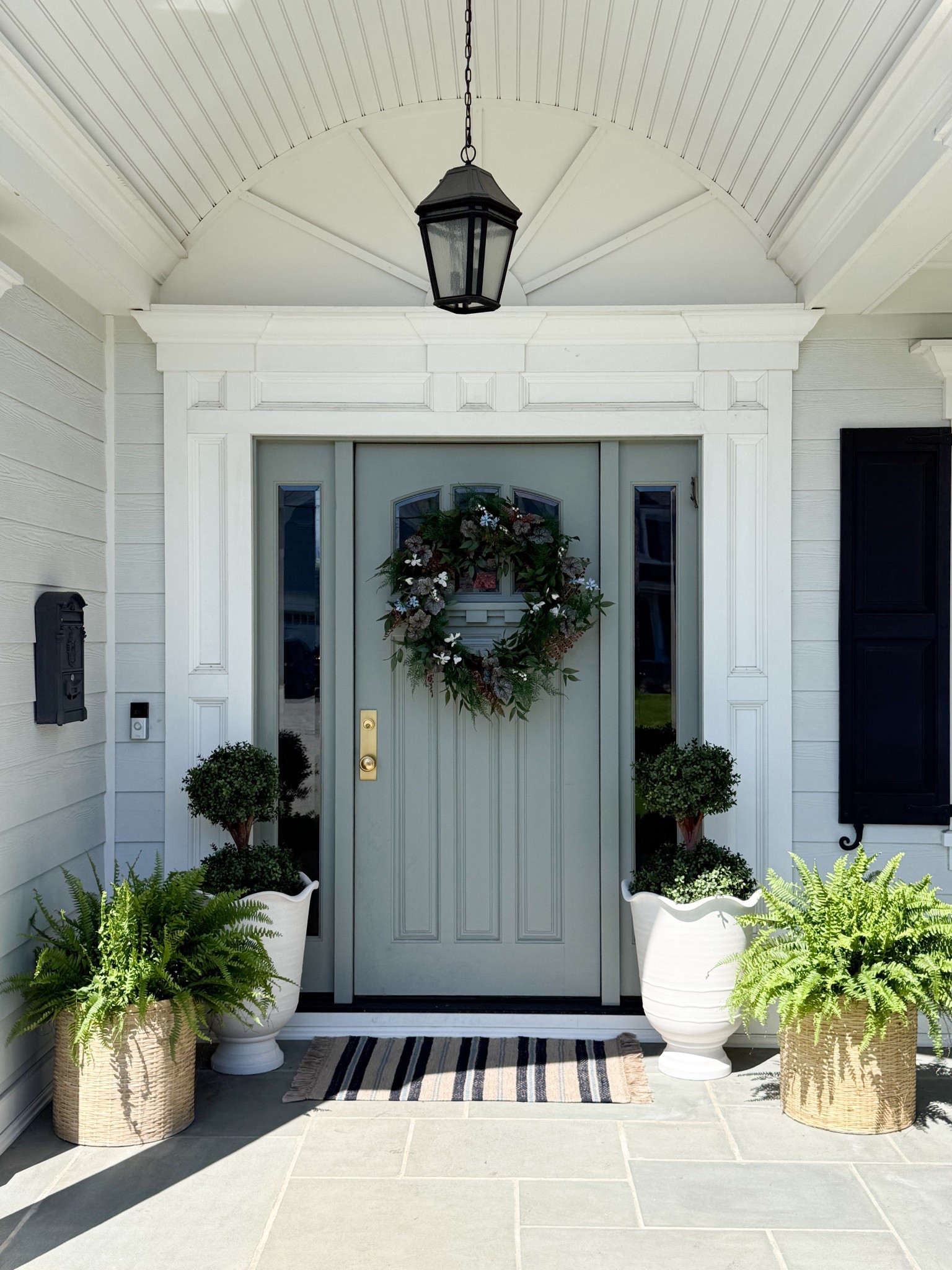 This front entry is such a good example of how a few classic pieces can completely elevate your porch. I love how the soft green door paired with the full greenery wreath creates a fresh focal point, while the layered planters and simple striped rug add texture and balance in such an effortless way. It’s an easy, timeless setup that feels welcoming year round.

front door decor ideas, outdoor planters styling, spring front porch decor, greenery wreath ideas, neutral exterior design, entryway curb appeal, layered outdoor planters, classic front porch styling, coastal exterior decor, outdoor entry styling, welcoming front door girlonthehudson

#LTKHome #LTKSeasonal