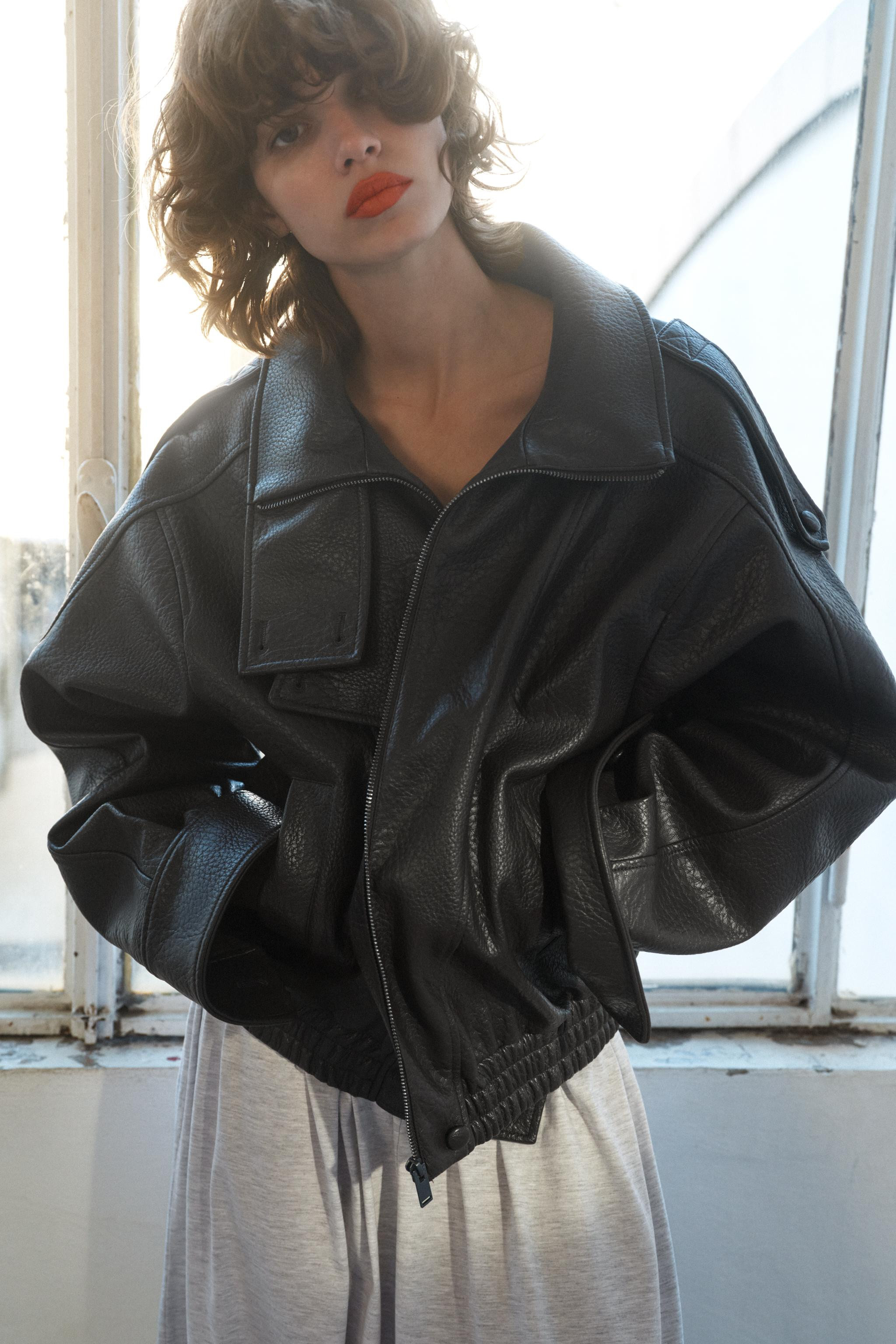 Jacket with a stand-up collar and long sleeves with tab detail on the shoulders. Side pockets. Co... | Zara UK
