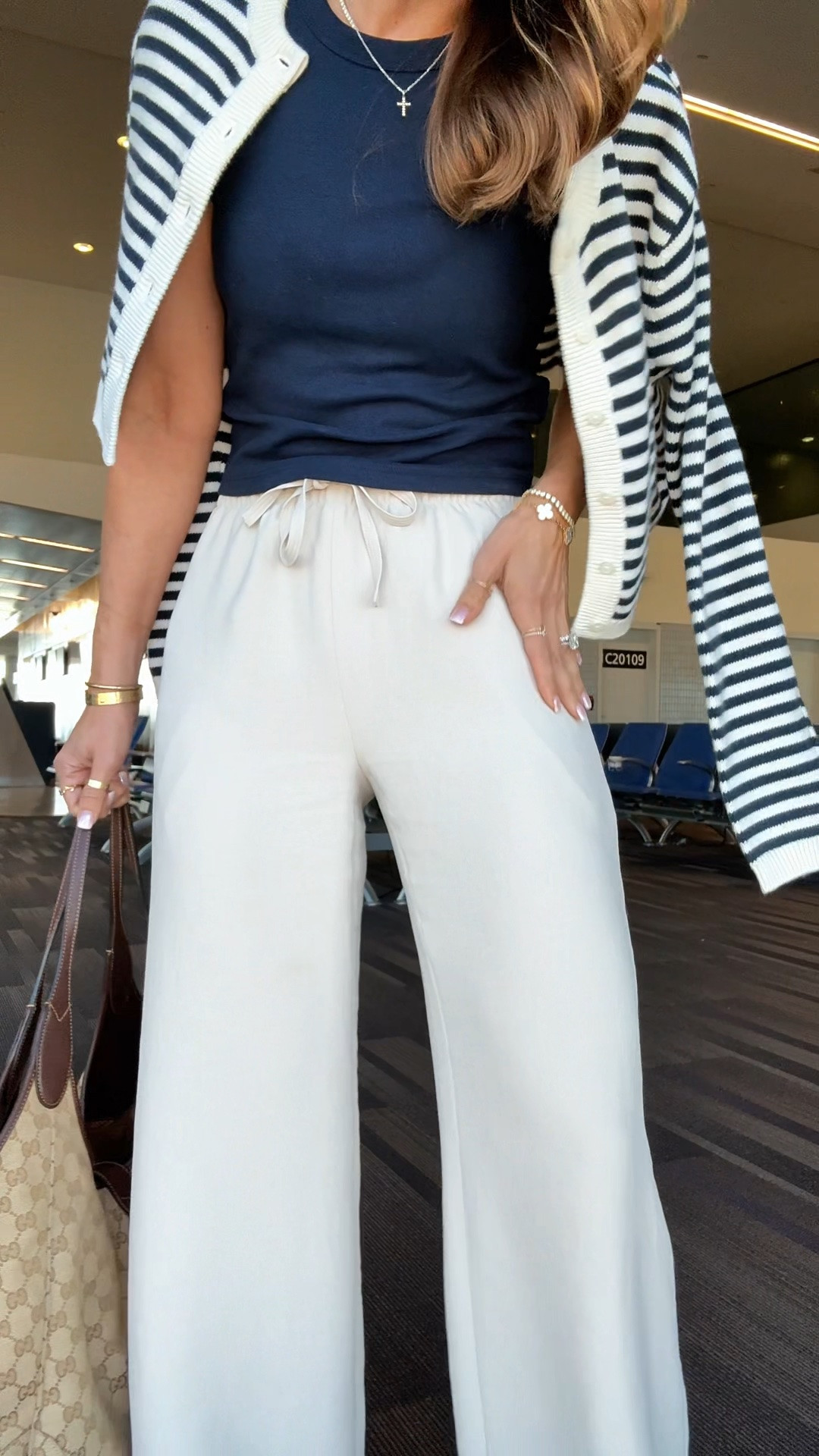My travel outfit of the day! Aritzia The Lodge Pant - Crepette. Size XS regular, color ‘Metropolis Taupe’. Comes in short and tall, too. Wrinkle resistant with an elastic waist and high-rise. Aritzia t-shirt in XS. Aritzia striped cropped cardigan in 2XS. Jelly ballet flats are whole sizes only. I’m a 6.5 and sized down to a 6 per reviews. Business casual. Elevated casual. Workwear. Coastal outfit.

#LTKootd #LTKTravel #LTKWorkwear
