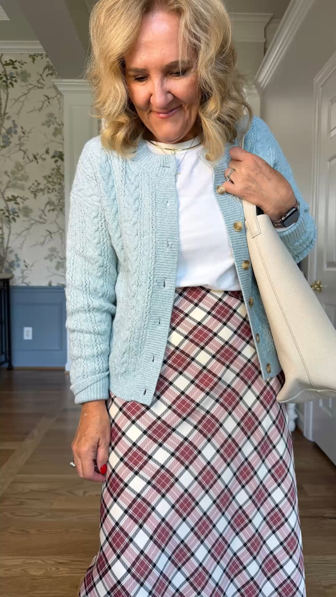 I really like this little combination of the soft blue cardigan and that plaid skirt. I’m wearing a medium in the sweater, a small in the white tee, and a medium in the skirt, and somehow it just feels very me.

#LTKootd #LTKPetite #LTKOver40