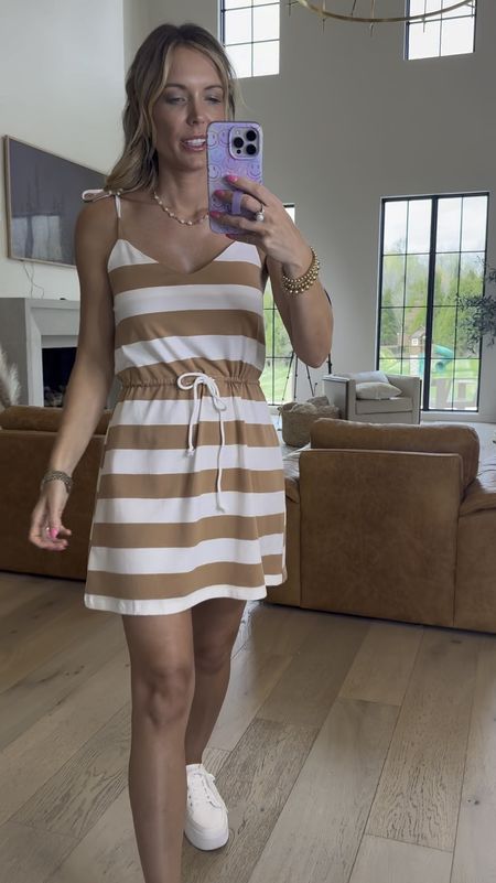 Love this cute striped dress for spring and summer. You could even add a bodysuit or tank underneath. Wearing it with tennis shoes to keep it looking casual, but you could dress it up with sandals. #PinkLily #Dress #SummerStyle #Coastal.

ToriG20 for discount 

#LTKsalealert #LTKstyletip #LTKfindsunder50