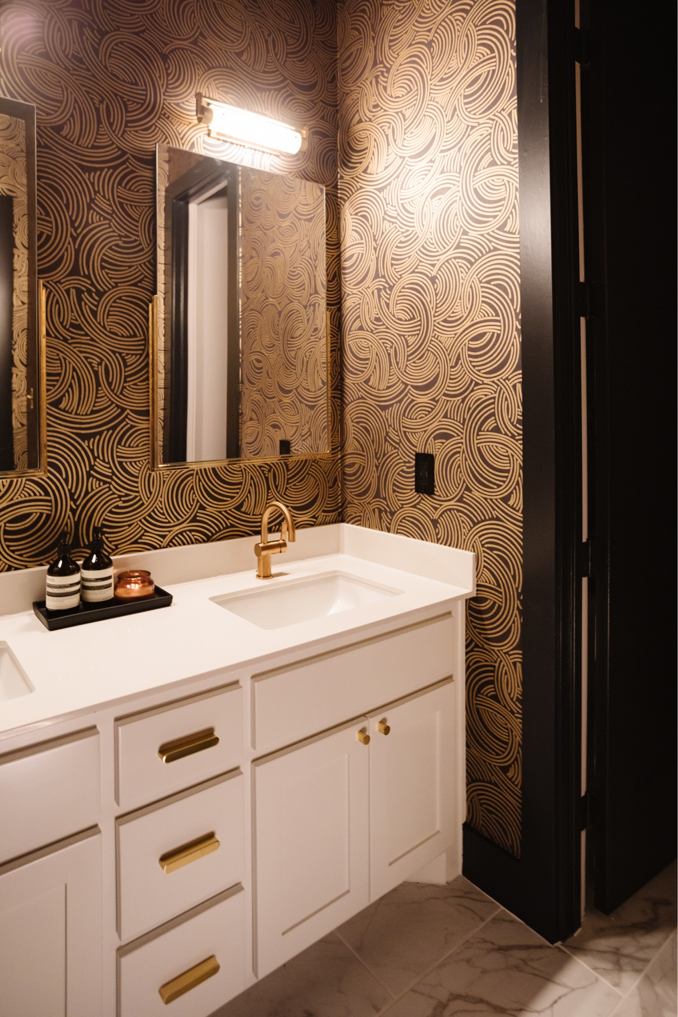Nothing I love more than a dramatic powder bath! Used black and gold wallpaper and off black paint to complete the look. Added gold mirrors, gold hardware and faucets, as well as modern picture lights to enhance the space! 

#LTKhome #LTKstyletip