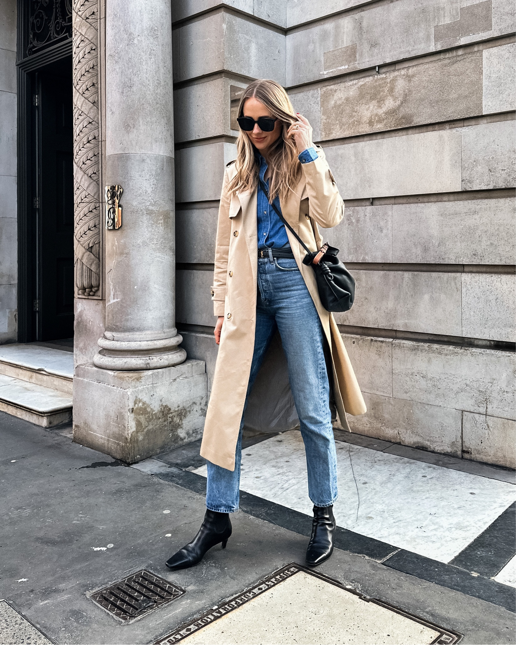 Fashion Jackson wearing long trench coat (small), denim shirt (link similar) AGOLDE jeans (tts) black boots, YSL belt, Loewe crossbody handbag #fashionjackson #london #springoutfit #capsuleoutfit #denimshirt #capsule 

#LTKstyletip #LTKshoecrush #LTKunder100