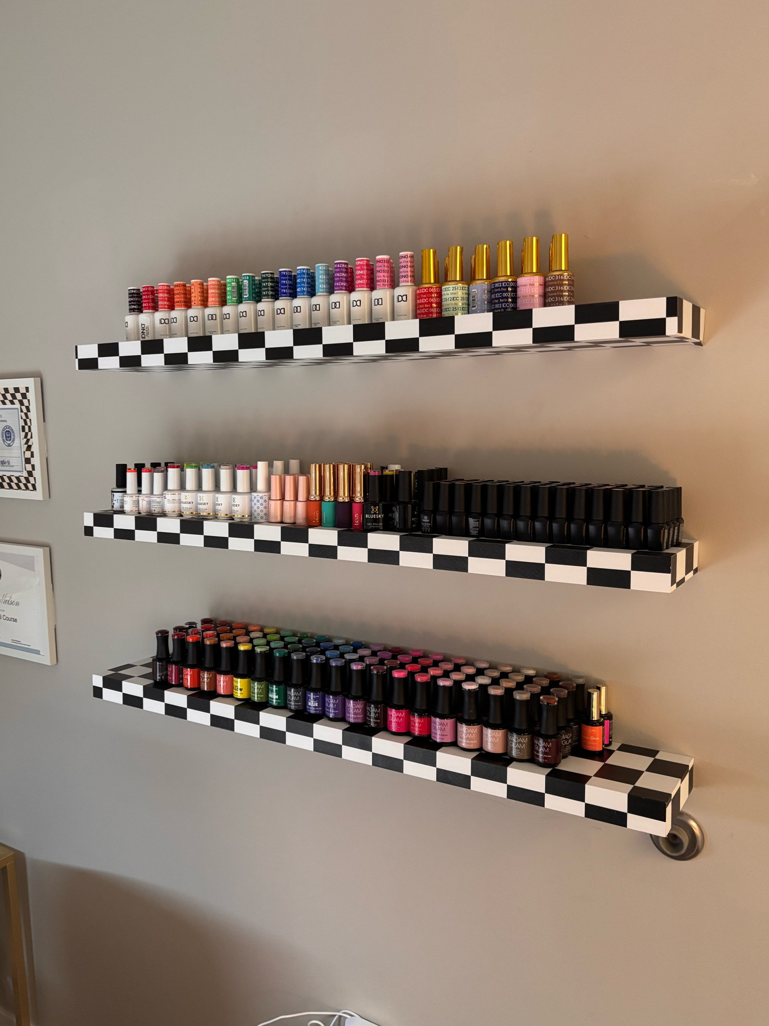 Nail salon inspo! Im so obsessed with these new polish shelves they hold so much product and are so easy!

Checkered shelves, nail tech salon inspo, private nail tech, nail room inspo, nail salon inspo, gel nail polish.