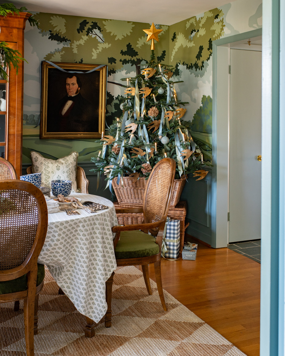 A view into the dining room, including the tree.  Since it's only a 5' tree, I put it into an antique market basket stacked on a lidded basket...   

 #LTKHoliday #LTKSeasonal #LTKHome