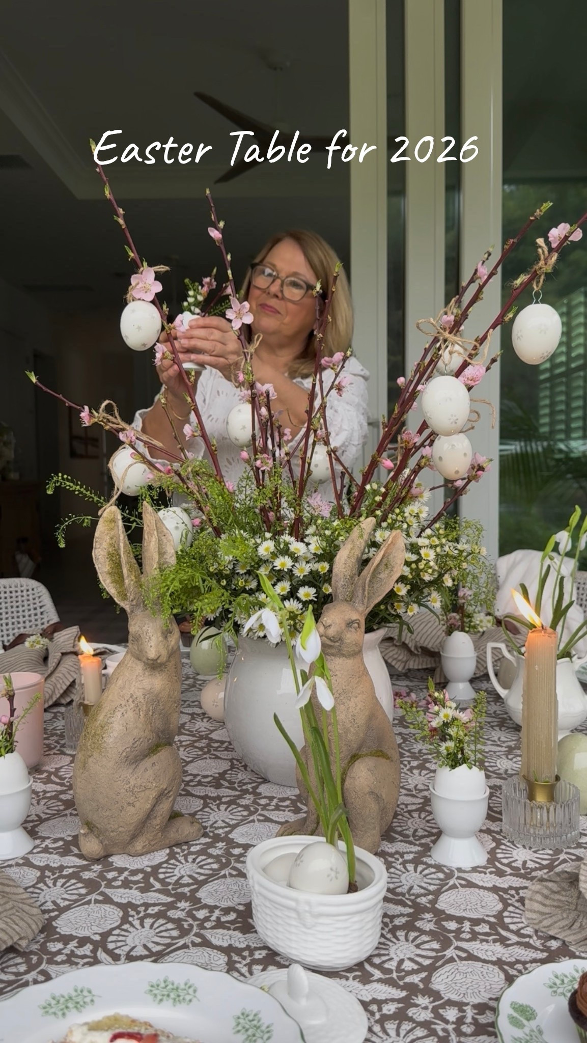 I just posted a reel sharing my Easter 2026 table.  I have to be honest it’s probably one of my favorites.  The centerpiece is cherry blossom branches surrounded with camomile flowers and then hung ceramic eggs from twine.  My adorable moss bunnies, white dishes and cream cabbage ware appetizer plates 