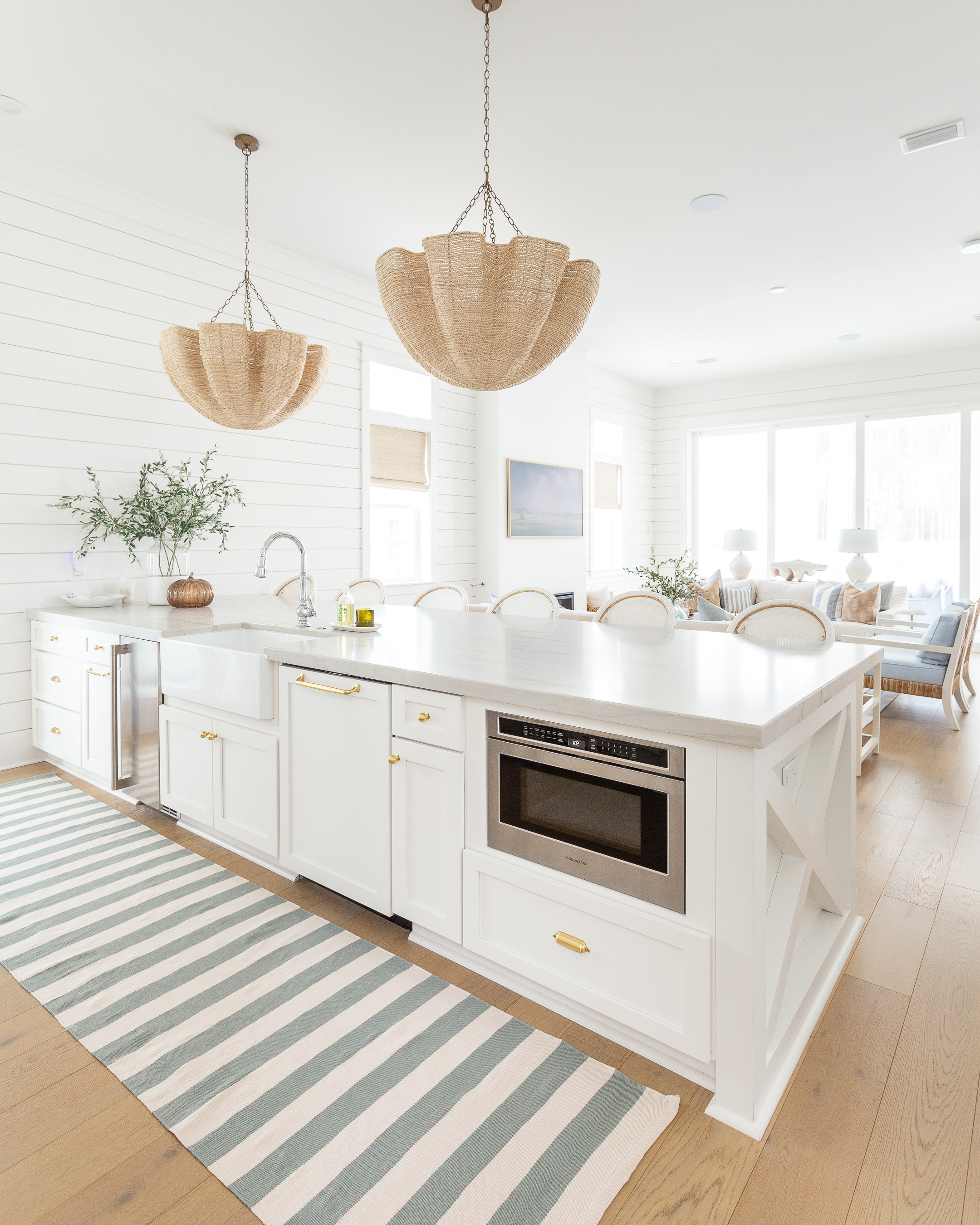 Coastal home kitchen // modern coastal kitchen decor // chandelier // rug runne  

 #LTKSeasonal #LTKHome
