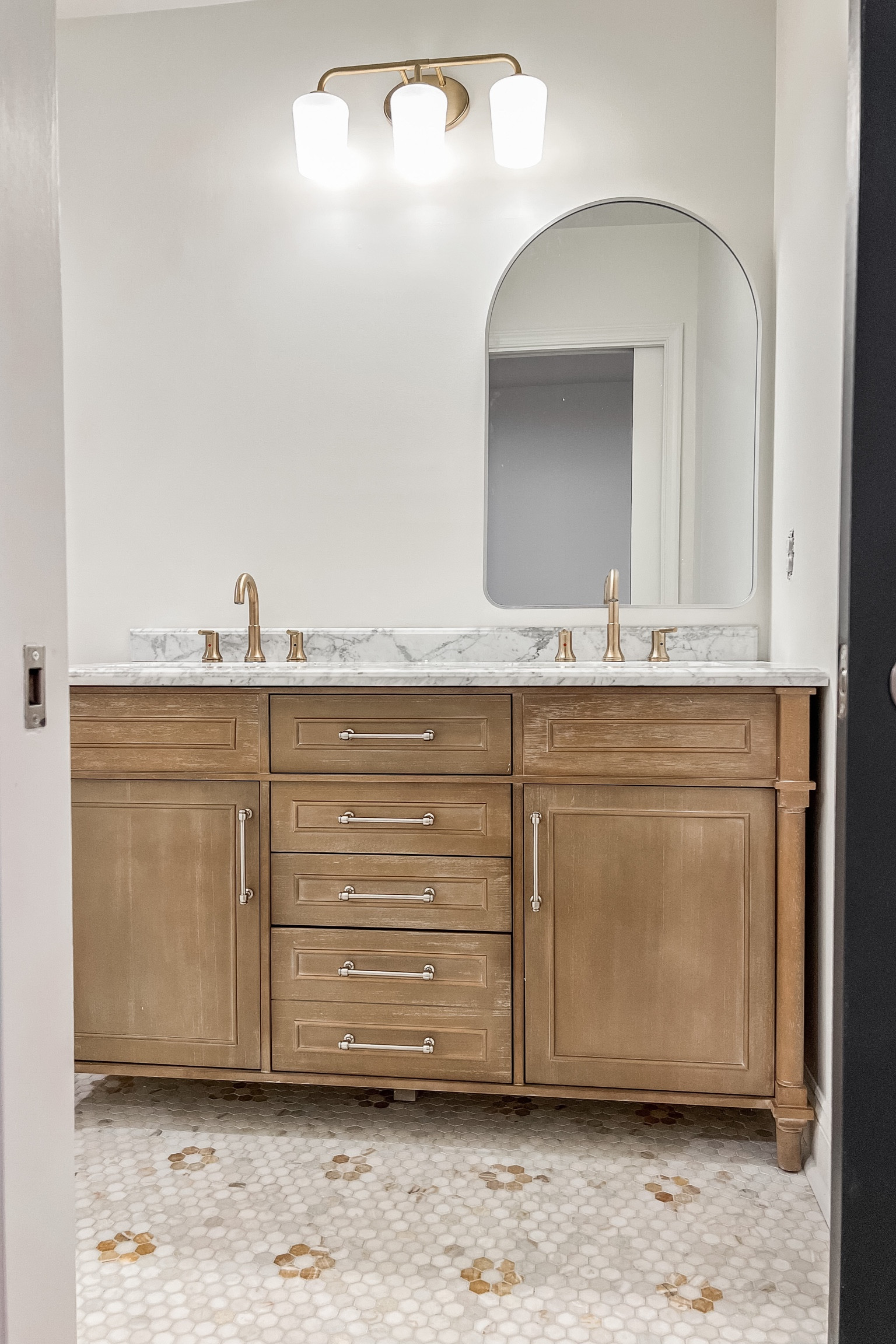 Girls bathroom renovation, Aberdeen vanity, Delta Trinsic Faucets, Champagne Gold, Brushed Nickel Mirrors, gold lighting, hex tile, marble flooring 

#LTKhome #LTKunder100 #LTKsalealert