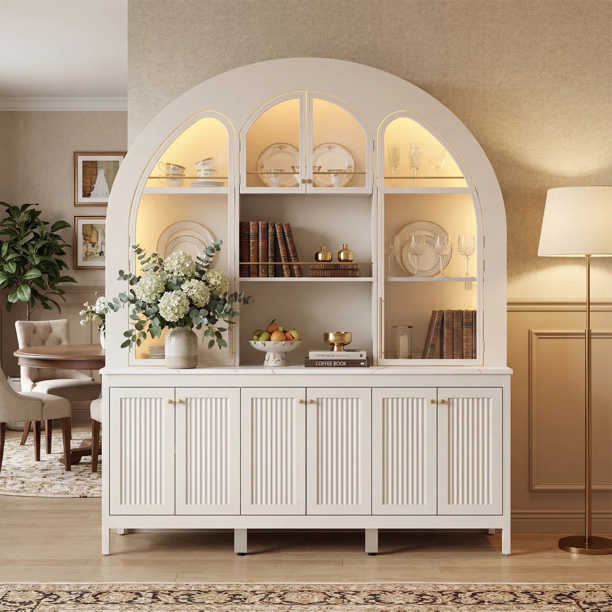 Inspired by European entertaining spaces, this arched wine cabinet combines elegant display shelving with ambient lighting for a polished and luxurious finish. ON SALE and under $750.

Keywords:

* glass wine cabinet
* arched wine cabinet
* LED wine storage
* modern bar cabinet
* luxury wine cabinet
* dining room storage cabinet
* illuminated display cabinet
* glass door storage cabinet
* boutique hotel aesthetic
* luxury entertaining space
* modern glam interiors
* curated home decor
* European inspired interiors
* elegant dining room decor
* statement storage furniture
* sophisticated home bar

#LTKSeasonal #LTKHome #LTKSaleAlert